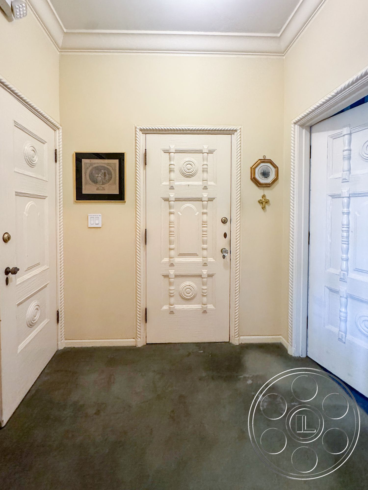 Adams Mansion - neutral wall color, subtle lighting fixtures, textured plaster walls, traditional design elements, double door entry, decorative crown molding details, interior entryway, classic wall art decor, intricate carved wooden doors, soft green carpet flooring, traditional decorative accents, elaborate door hardware, framed wall photographs, ornate door trim