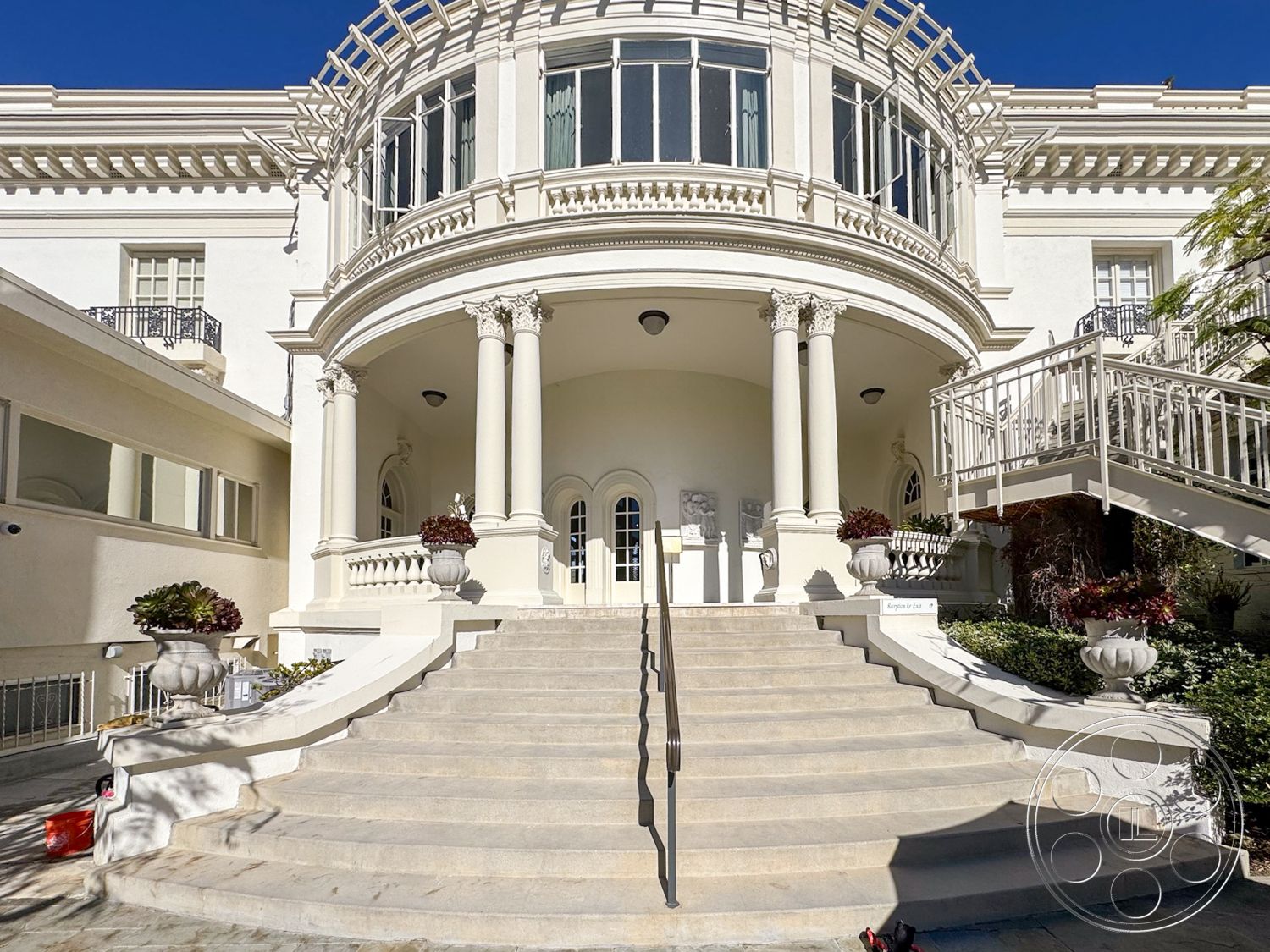 Adams Mansion - coffered ceiling, exterior, landscaped garden, white stucco walls, symmetrical facade, arched doorways, stone steps, grand staircase, formal entryway, wrought iron balcony railings, dome-style porch ceiling, fluted columns, multilight windows, ornate planter urns, geometric roofline, balustrade railing, tapered column bases