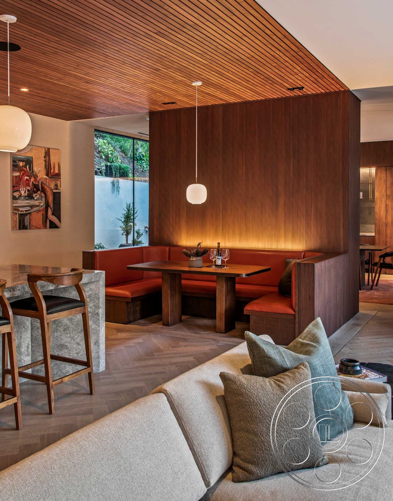 Modern 520 - interior dark wood paneling, interior floor-to-ceiling windows, interior cozy seating area, interior ambient lighting, interior decorative throw pillows, interior sectional sofa, interior open layout, interior hardwood herringbone flooring, interior wood ceiling panels, interior modern dining table, interior round pendant lighting, interior upholstered bench seating, interior natural stone countertop, interior red upholstery, interior glass wall view, interior decorative art wall