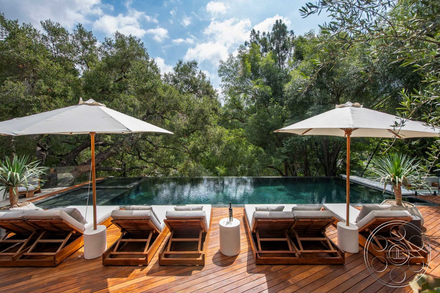 Modern 520 - infinity pool, outdoor relaxation space, outdoor entertaining area, modern outdoor lounge area, natural landscape view, al fresco dining potential, slate stone accents, lush greenery surroundings, wooden deck flooring, concrete pool border, minimalist landscape architecture, modern exterior design, exterior wooden decking, open-air lounge space, contemporary pool design, sun-drenched outdoor area, stylish wooden lounge chairs, beach umbrella shade, integrated water feature, elevated pool design