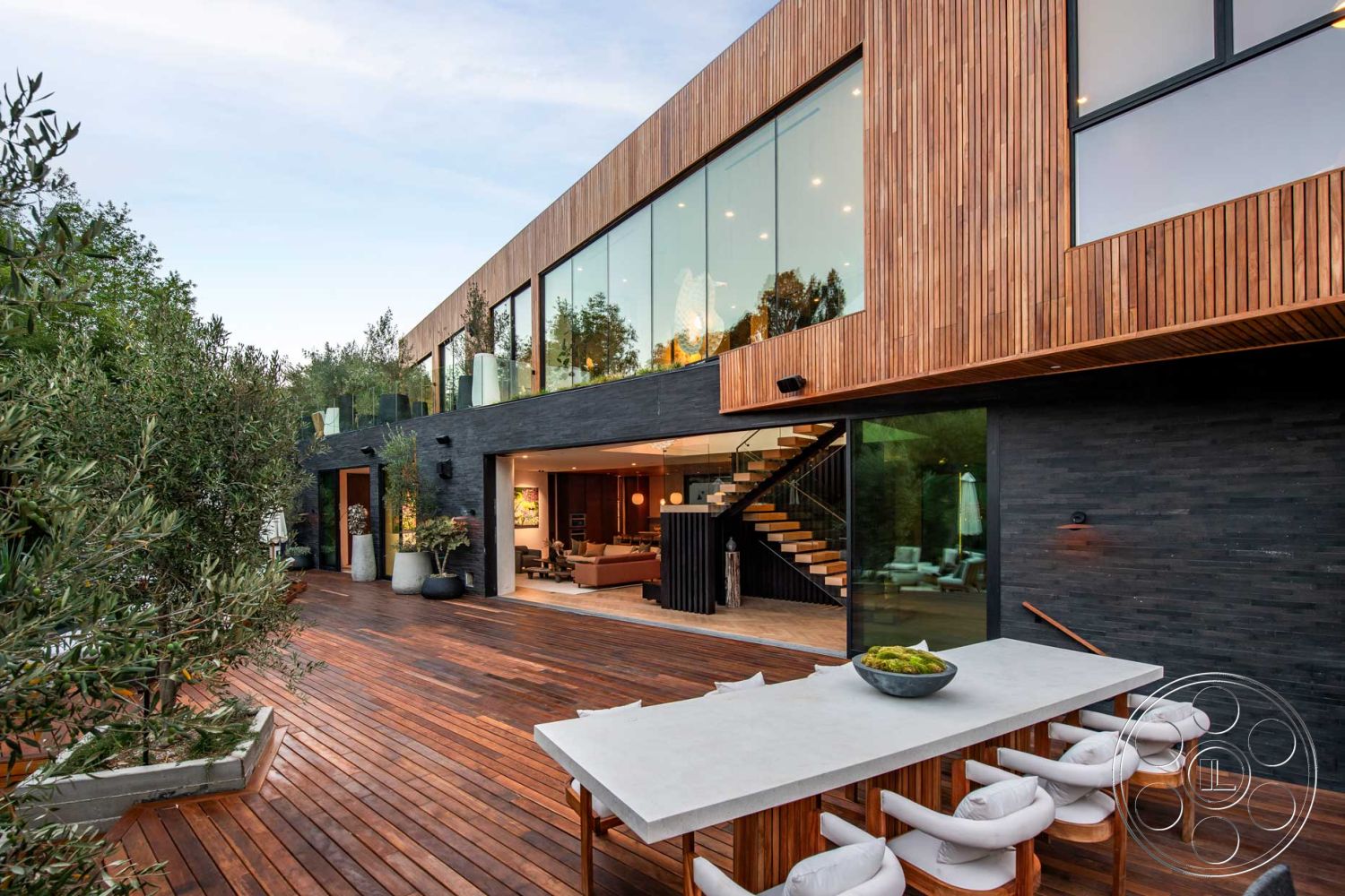 Modern 520 - natural light, wooden flooring, sliding glass doors, curved pathway, urban setting, wooden beam ceiling, floor-to-ceiling windows, modern architectural style, dark wood paneling, modern patio furniture, black stucco walls, exposed wood ceiling beams, open concept living area, exterior wooden deck, contemporary home design, rectangular outdoor dining area, steel stair railings, landscaped tropical garden, concrete outdoor dining table, large glass balcony, chef's kitchen with island, vaulted ceilings