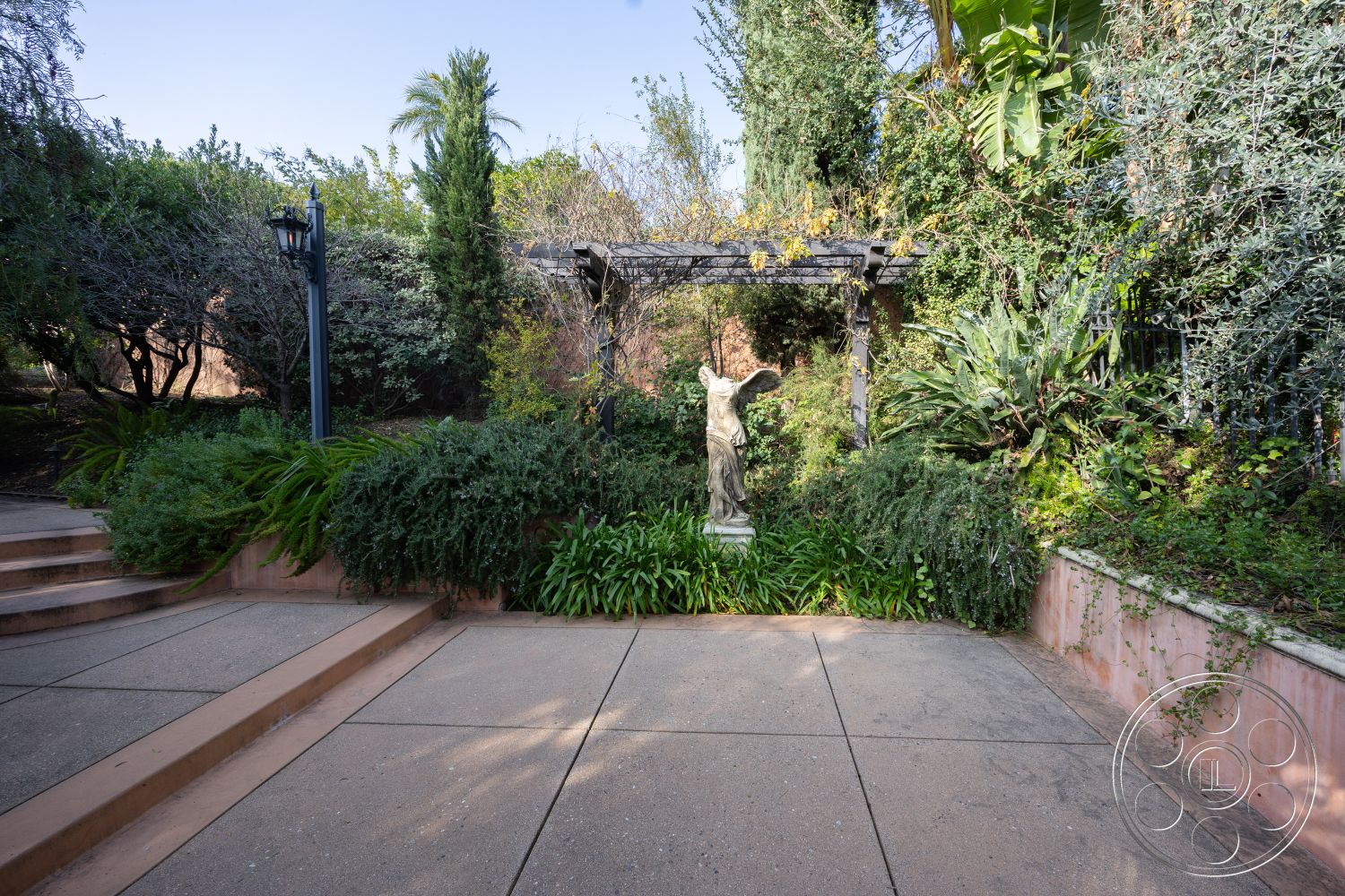 Mansion 145 - exterior natural stone accents, exterior stone garden walls, exterior patio flooring concrete, exterior staircase with concrete steps, exterior lush garden landscaping, exterior wooden pergola structure, exterior ornamental statue feature, exterior ambient garden lighting, exterior low-maintenance plants, exterior tropical palm trees