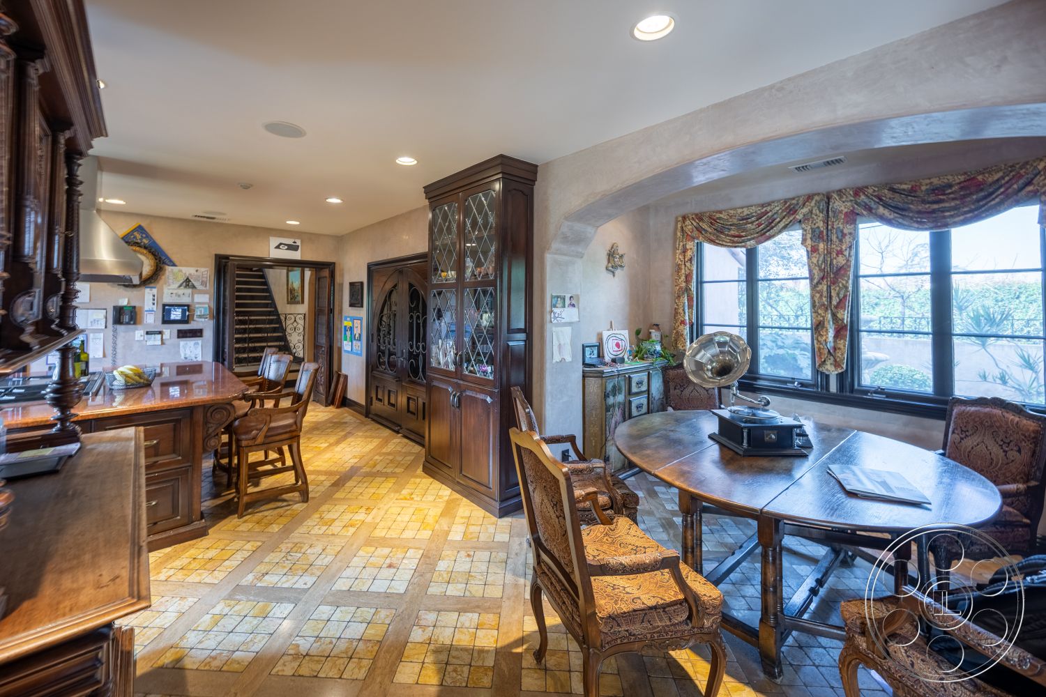 Mansion 145 - interior exposed wood ceiling beams, interior floor-to-ceiling windows, interior cozy seating arrangement, interior natural light-filled space, interior open floor plan layout, interior decorative crown molding, interior patterned area rug, interior tile kitchen flooring, interior upholstered dining chairs, interior hardwood kitchen cabinetry, interior granite kitchen countertop, interior antique dining room table, interior wrought iron staircase railing, interior ornate window treatments, interior plaster accent walls, interior glass display cabinet, interior formal dining area, interior breakfast bar seating, interior vintage decor accents, interior wall-mounted artwork