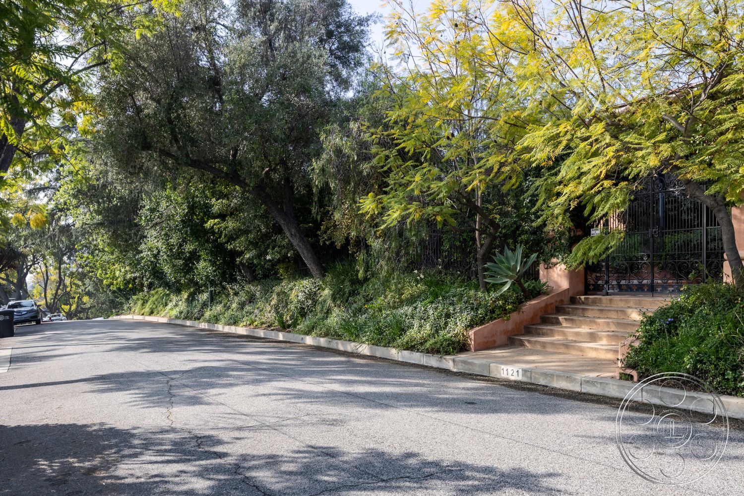 Mansion 145 - exterior stucco wall, exterior landscaped garden, exterior stone pathway, exterior hillside location, exterior concrete steps, exterior foliage, exterior wrought iron gate, exterior flowering shrubs, exterior tree canopy, exterior uneven terrain, exterior soft natural light, exterior residential street, exterior suburban setting, exterior urban greenery, exterior decorative gate, exterior vibrant landscaping