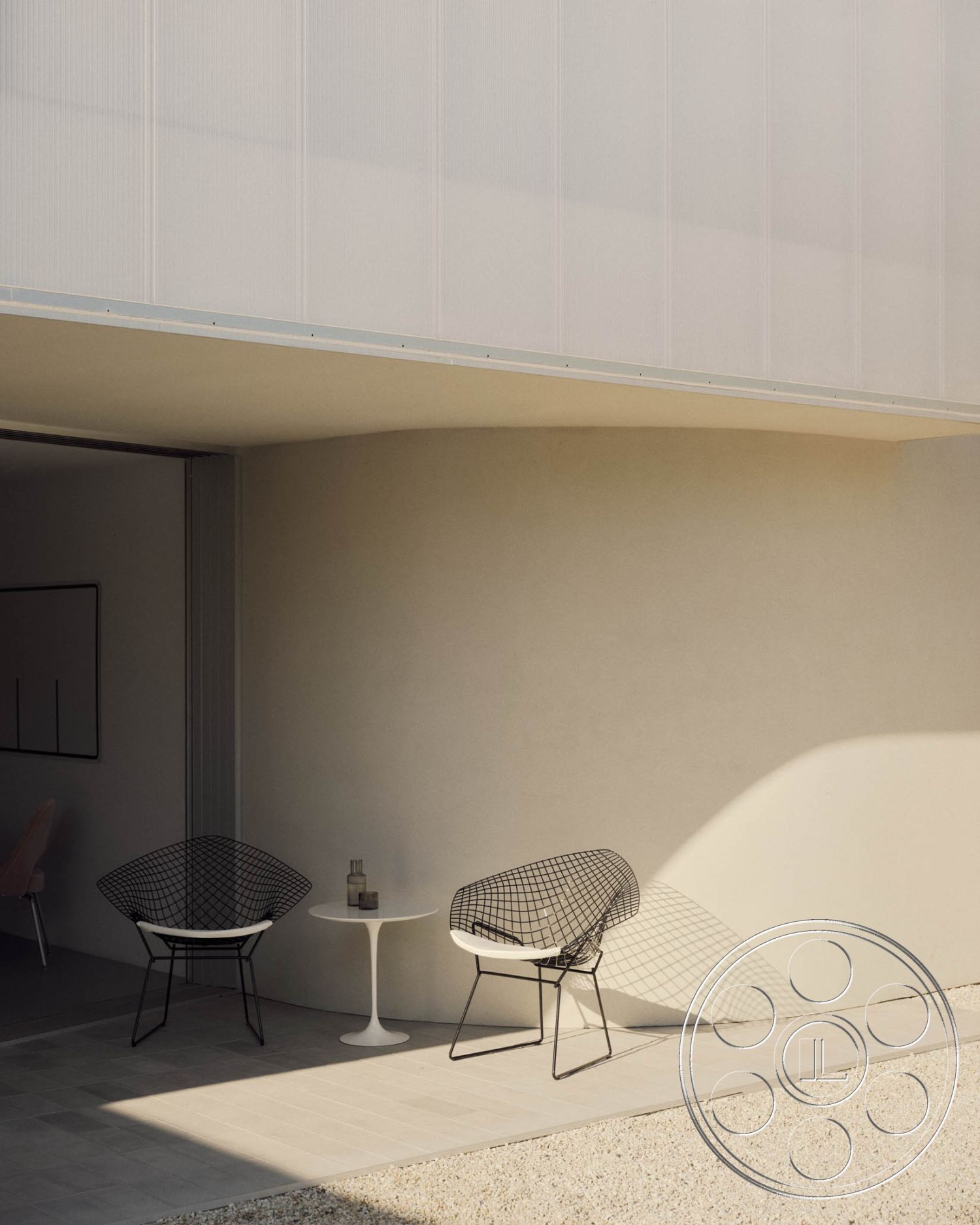 Modern 521 - neutral color palette, textured wall finish, seamless indoor-outdoor flow, contemporary outdoor space, open-air seating area, exterior concrete patio floor, modern minimalist aesthetic, minimalist architectural design, geometric shapes in furniture design, natural light shadows, exterior smooth plaster wall, modern metal wire patio chairs, round white outdoor patio table, landscaped gravel setting