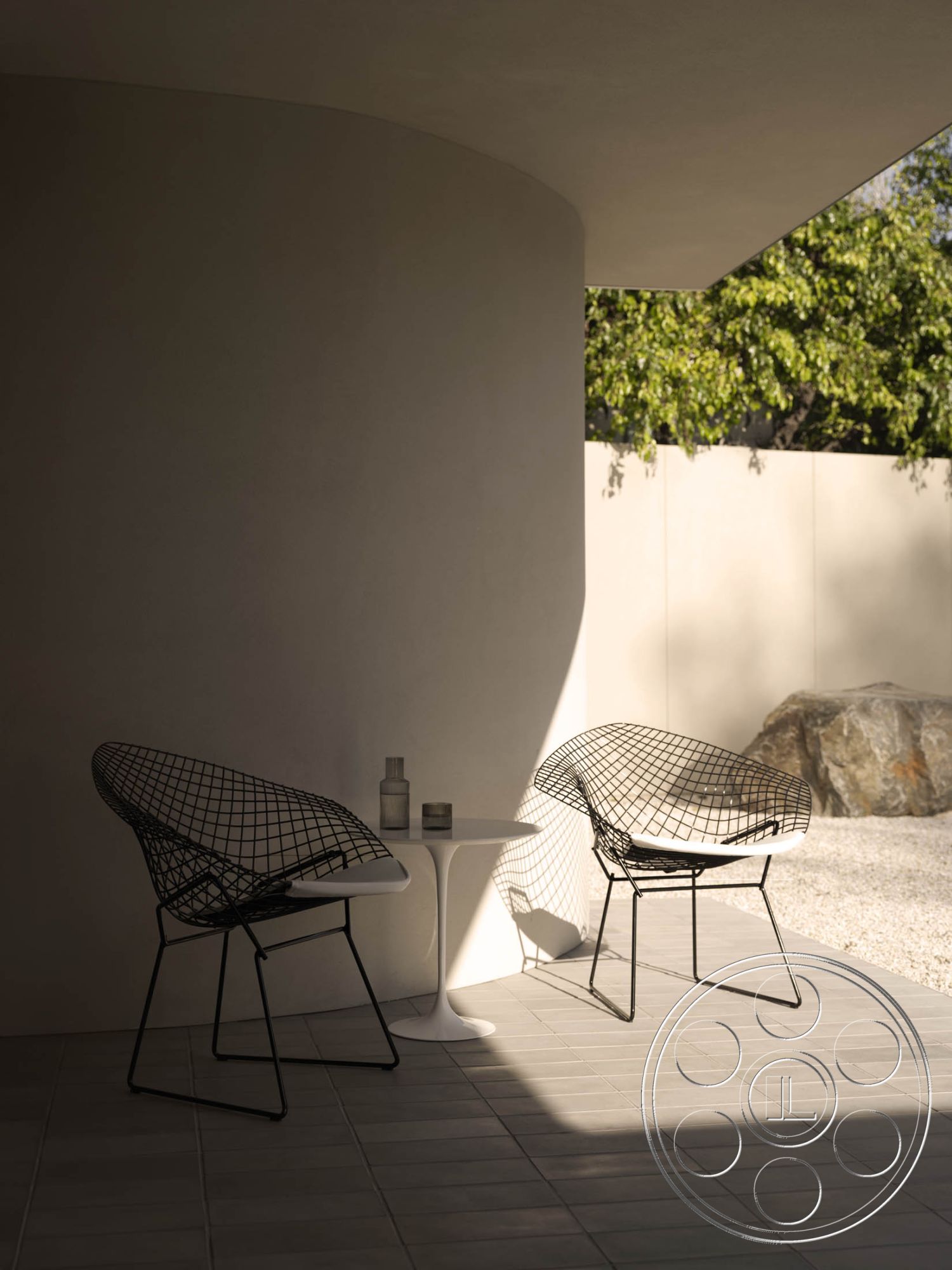 Modern 521 - neutral color palette, textured concrete flooring, contemporary design elements, soft ambient lighting, curved wall design, wireframe lounge chairs, plaster wall finish, lush green landscaping, natural stone accent, exterior patio area, minimalist outdoor furniture, open-air relaxation space, modern round side table, smooth surface textures