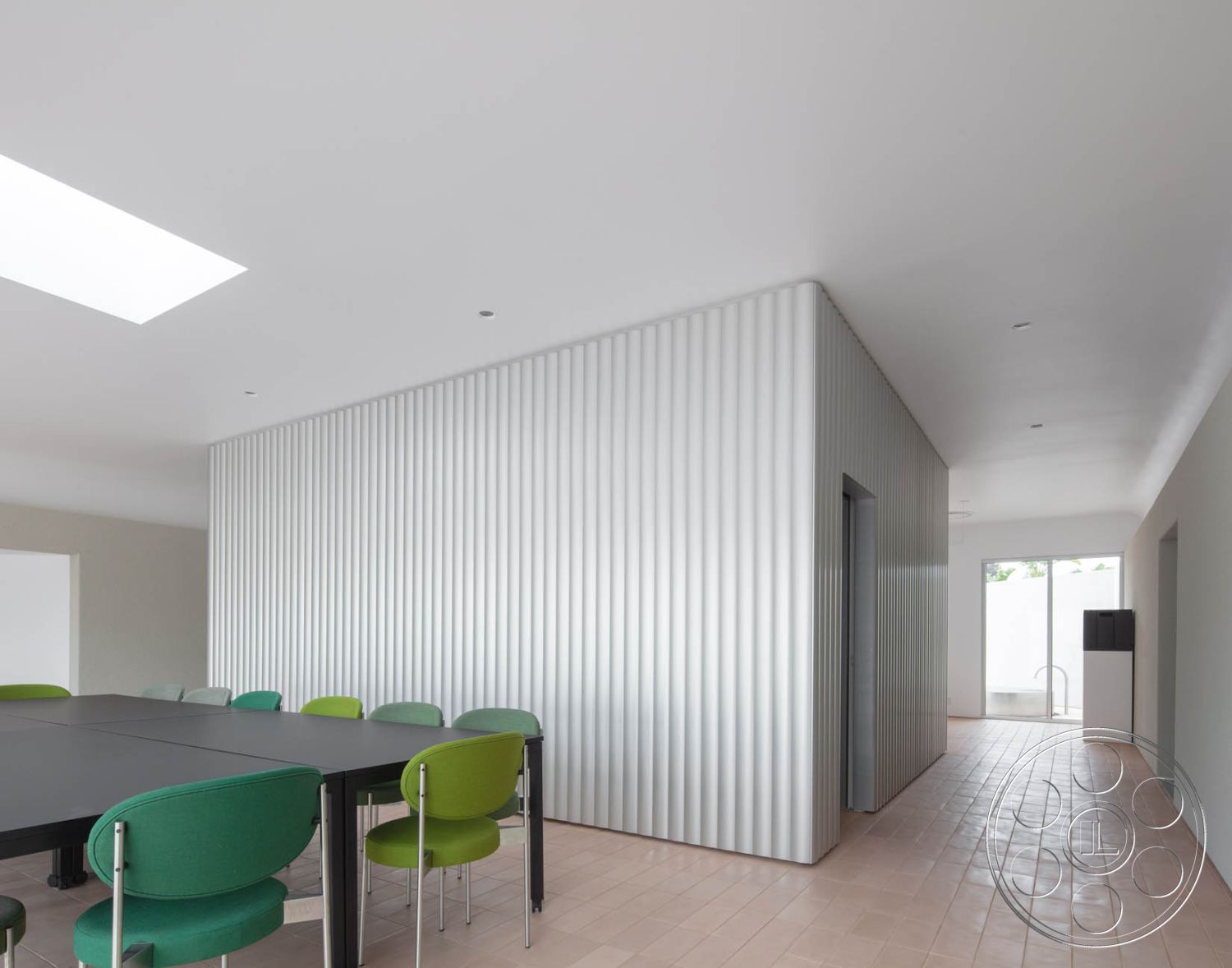 Modern 521 - natural light, minimalist design, open floor plan, modern architectural style, green upholstered chairs, rectangular conference table, plaster ceiling, drywall painted walls, vertical corrugated metal wall, black laminate tabletop, square ceramic floor tiles