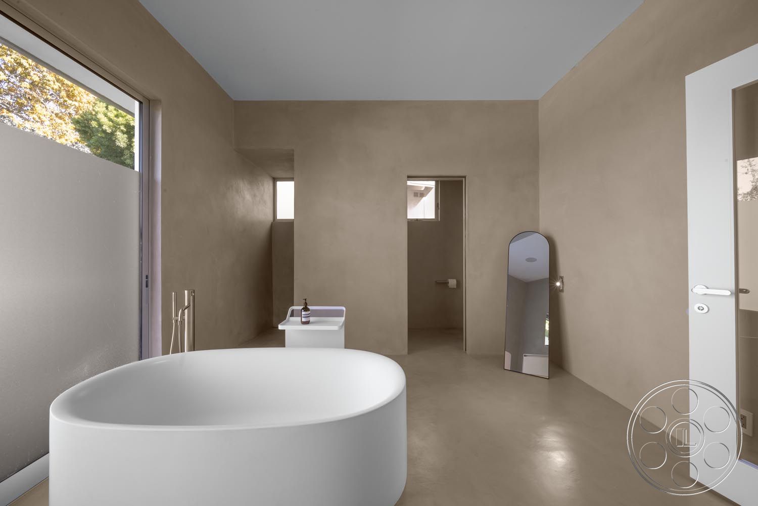 Modern 521 - neutral color palette, natural light, tranquil atmosphere, textured wall treatment, minimalist interior design, functional bathroom space, concrete bathroom flooring, simple geometric forms, textured ceiling finish, smooth plaster walls, large glass window, open bathroom layout, curved freestanding bathtub, modern door, contemporary mirror design, access to outdoor views