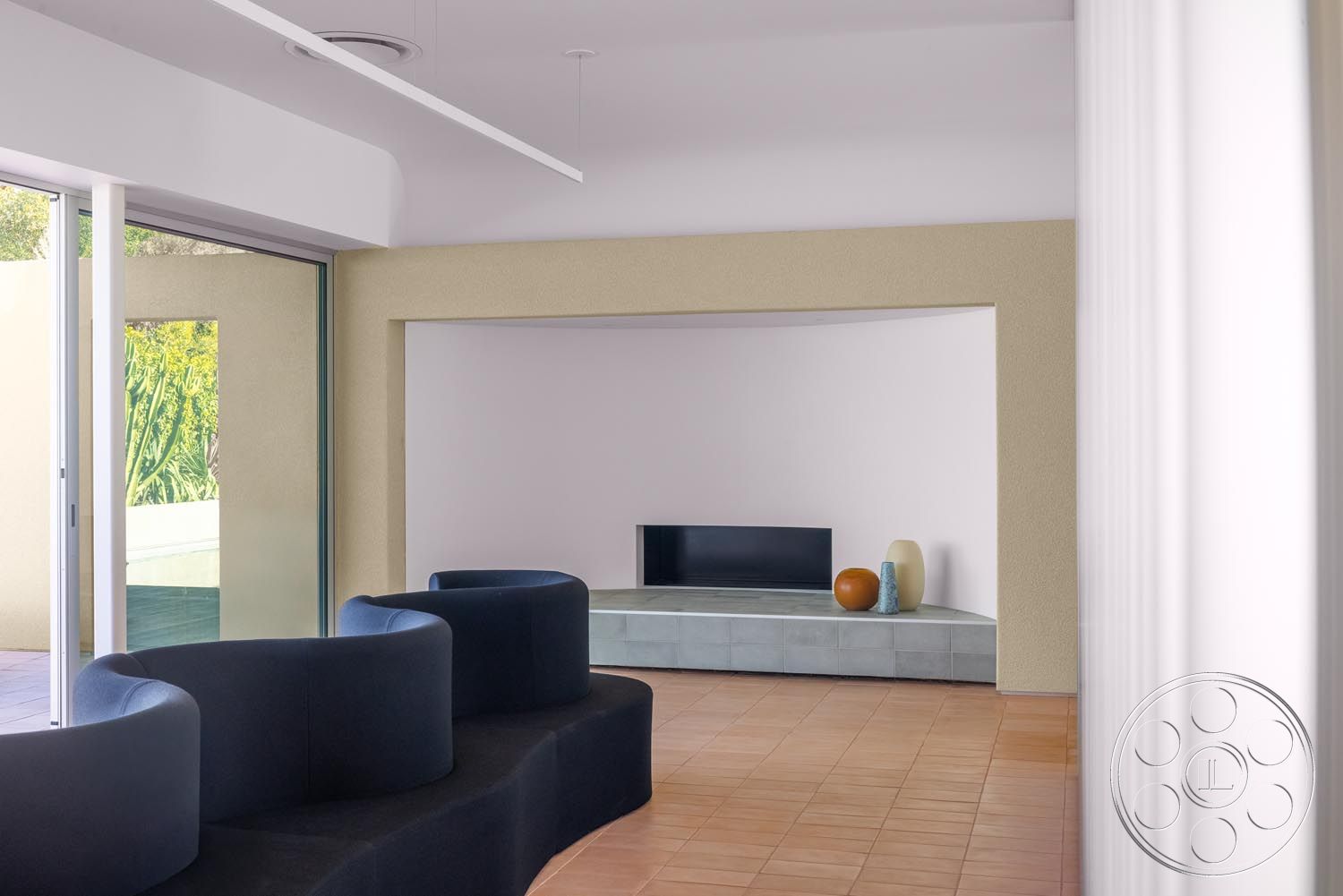 Modern 521 - neutral color palette, natural light, tile flooring, minimalist design, large glass sliding doors, open space layout, indoor-outdoor flow, textured plaster walls, curved sectional sofa, potted plant accents, interior modern living room, contemporary decor elements, concrete bench seating, rectangular television niche