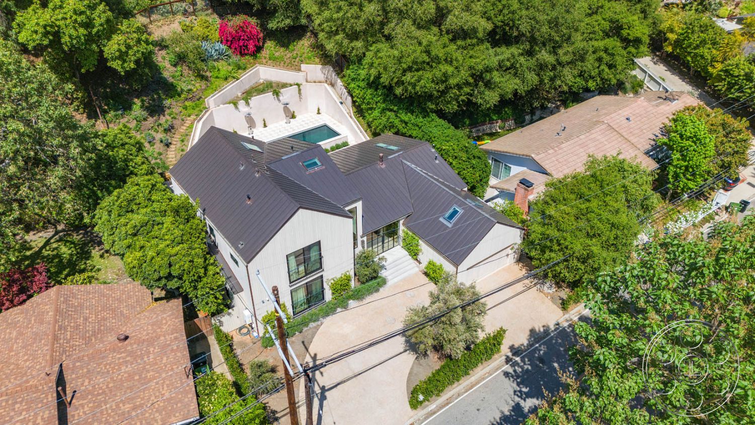 Modern Farmhouse 19 - rectangular swimming pool, floor-to-ceiling windows, stone pathway, concrete driveway, garden landscaping, minimalist architecture, drought-tolerant plants, lush green trees, stucco wall finish, concrete pool border, sunlit outdoor space, urban surroundings, exterior modern house, metal roof design, hardscaped pool patio, views of neighboring homes, large outdoor deck, surrounding nature setting