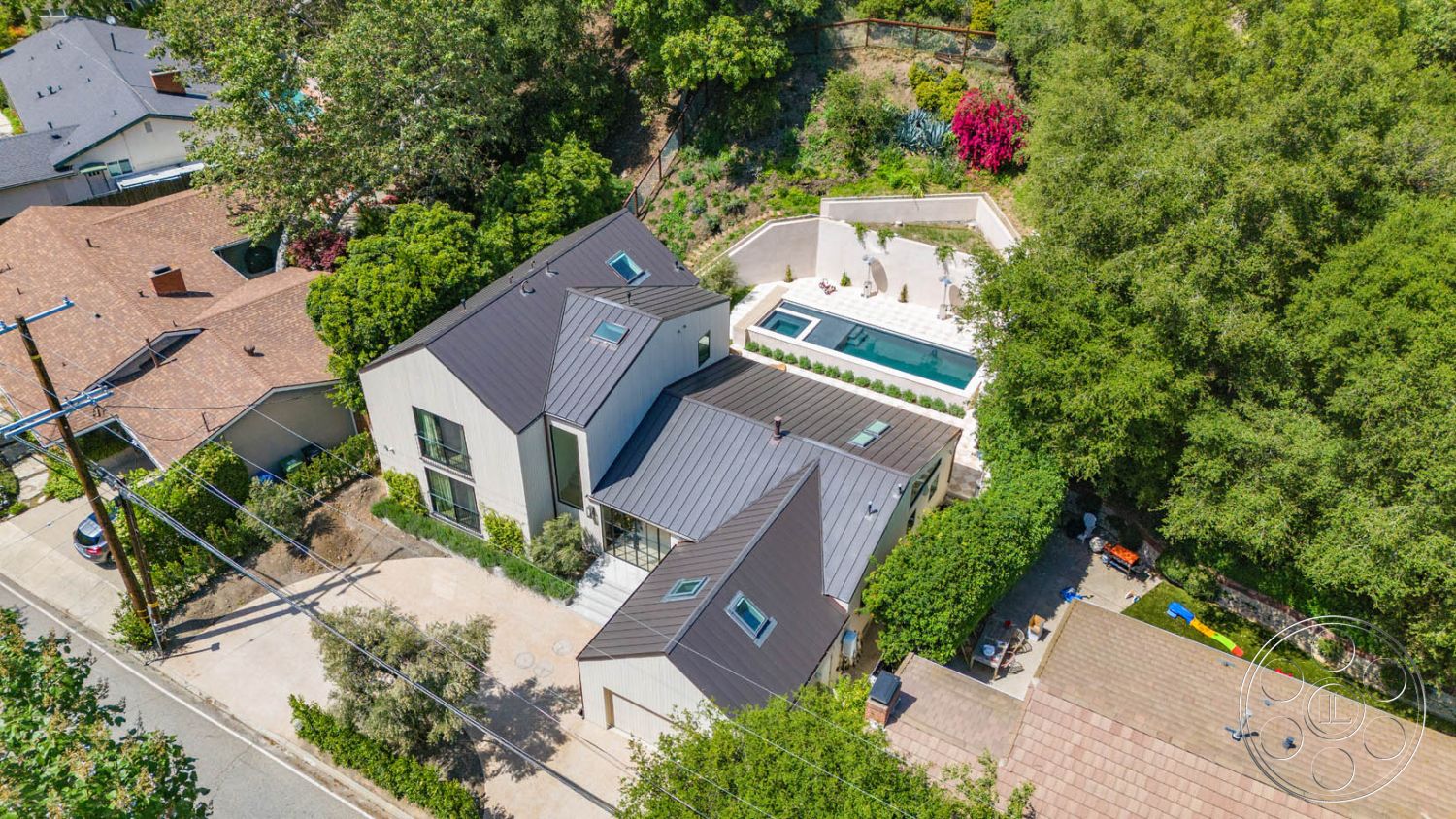 Modern Farmhouse 19 - rectangular swimming pool, floor-to-ceiling windows, curved driveway, open-concept layout, concrete pool deck, hardscape patio, drought-resistant landscaping, exterior glass sliding doors, minimalist exterior design, urban residential neighborhood, large overhanging eaves, exterior wood siding, vaulted ceiling in living area, tropical garden setting, lush green surroundings, built-in outdoor seating area, exterior standing seam metal roof, landscaped backyard with flowering shrubs, exposed brick patio walls, modern farmhouse architectural style