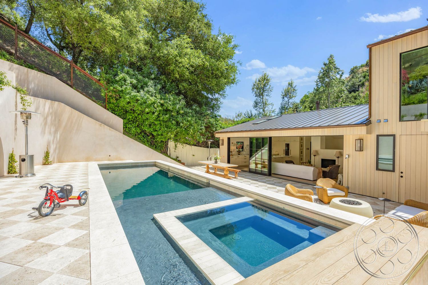 Modern Farmhouse 19 - glass sliding doors, modern outdoor furniture, landscaped greenery, rectangular swimming pool, concrete pool deck, outdoor relaxation area, modern residential architecture, urban hillside location, natural light-filled living space, stone patio flooring, exterior pool area, plaster pool finish, chequered tile patio surface, wood deck surround, minimalist garden setup, metal fence for privacy, wooden beam overhang, sustainable outdoor environment