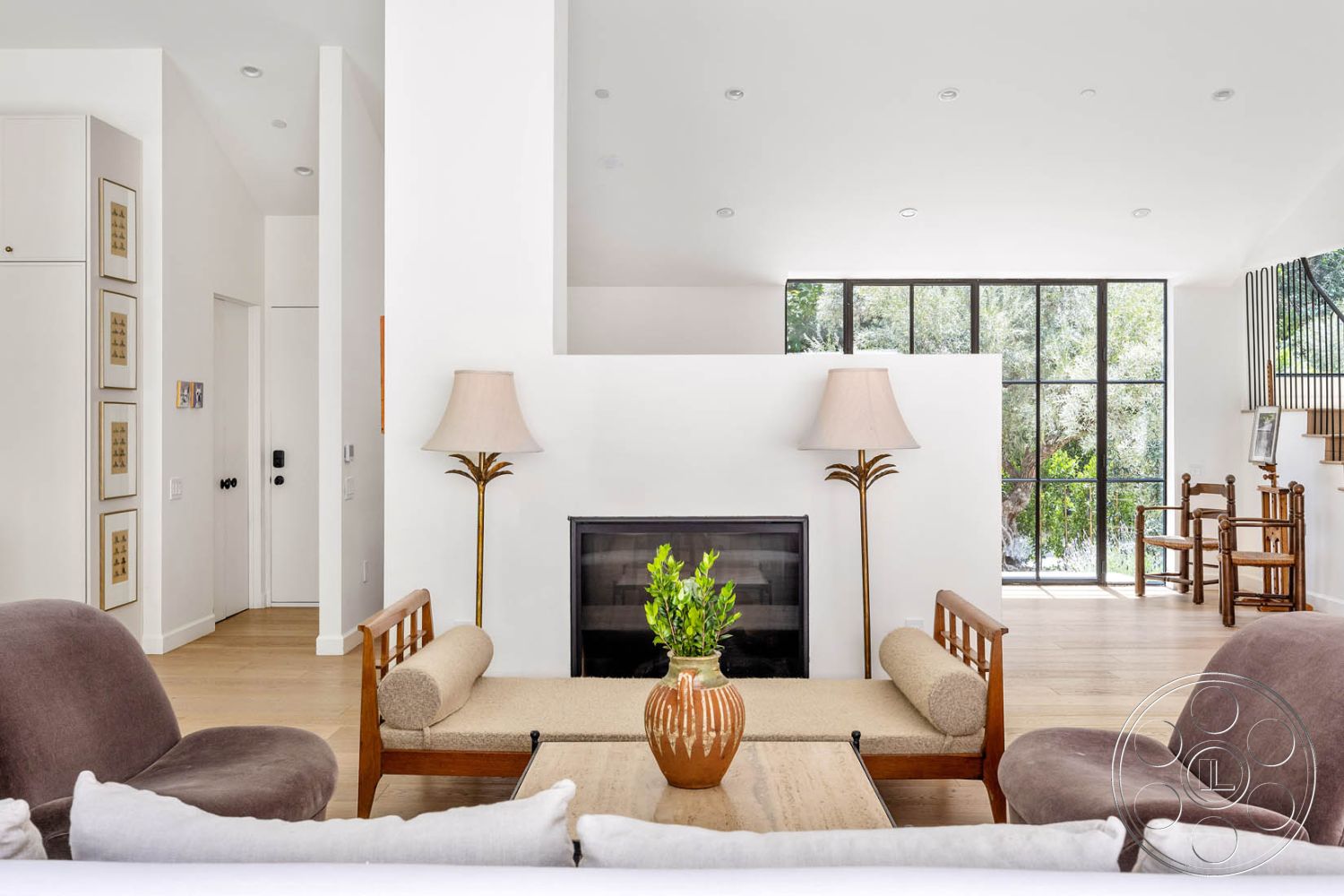 Modern Farmhouse 19 - interior hardwood living room floors, interior floor-to-ceiling windows, interior white painted walls, interior open floor plan, interior contemporary furniture, interior natural light ambiance, interior decorative wall art, interior modern accent chairs, interior modern fireplace wall, interior decorative table centerpiece, interior minimalist lighting fixtures, interior soft beige upholstery, interior geometric staircase design, interior warm tonal color palette, interior integrated shelving units, interior stylish table lamps, interior open view to garden, interior cozy sitting area, interior sleek curtain panels, interior textured elements with natural tones