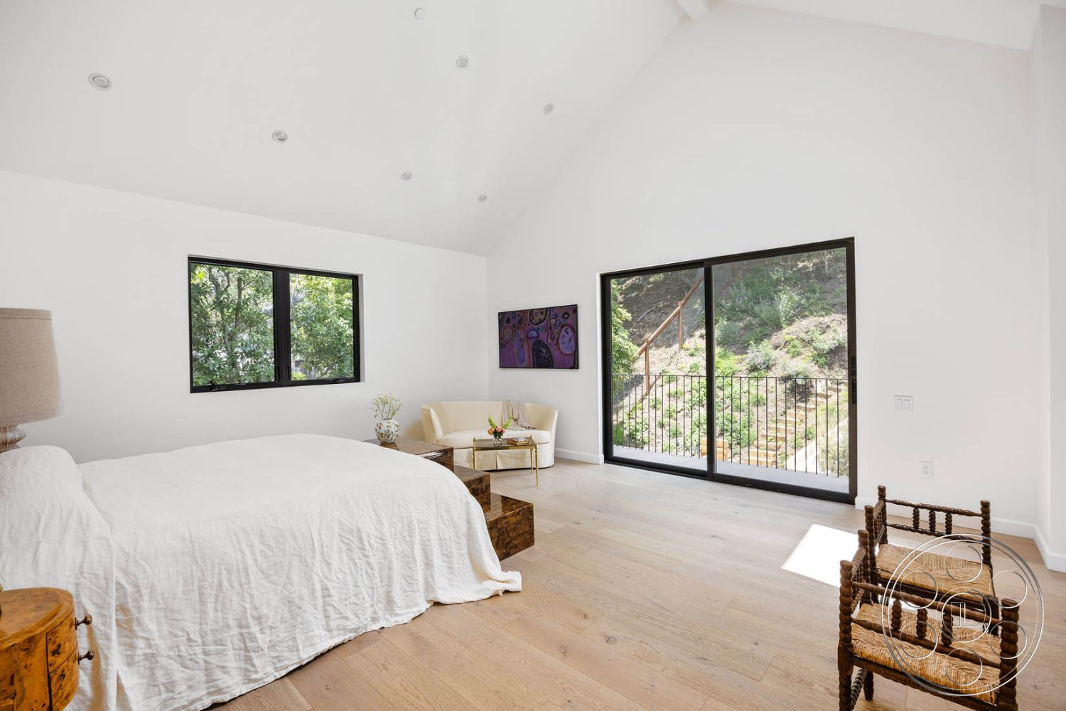 Modern Farmhouse 19 - contemporary furniture, open floor plan, modern interior, floor-to-ceiling windows, exposed wood ceiling beams, minimalist design aesthetic, hardwood bedroom floors, white painted walls, natural light filled room, textured linen bedding, wood accent details, black framed sliding glass doors, view of landscaped outdoor setting