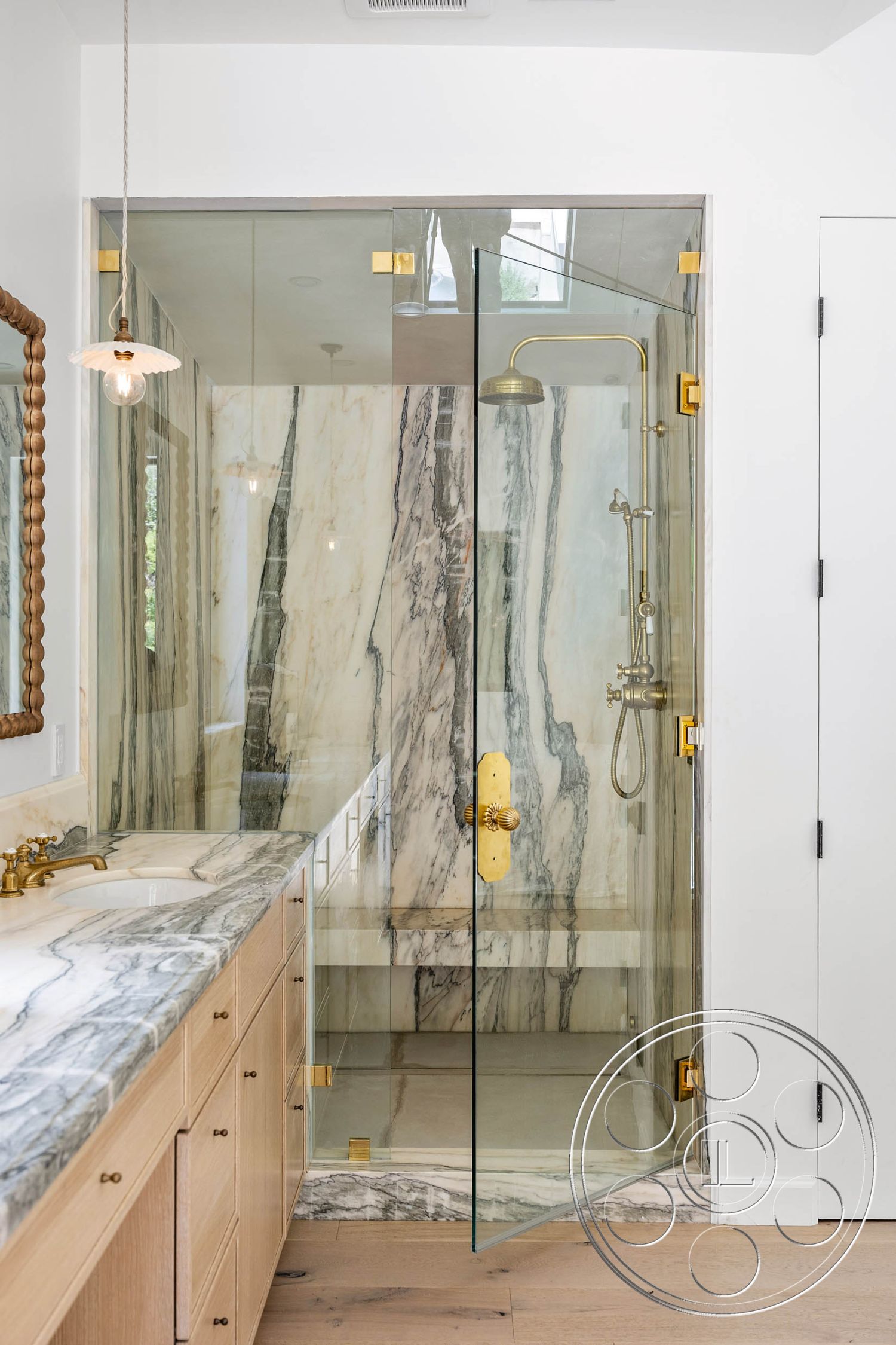 Modern Farmhouse 19 - interior gold faucet fixtures, interior minimalist design, interior marble bathroom walls, interior marble shower walls, interior glass shower doors, interior modern bathroom, interior stone shower flooring, interior wood vanity cabinetry, interior pendant lighting, interior textured wood flooring, interior functional layout, interior luxury finishes