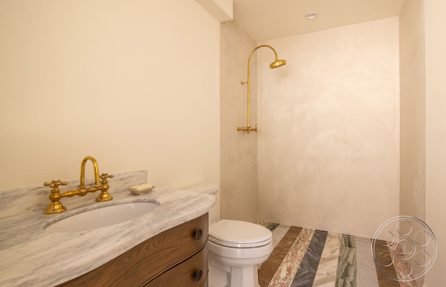 Modern Farmhouse 19 - minimalist design, soft neutral color palette, modern aesthetic, textured plaster walls, luxury bathroom, interior bathroom, marble countertop sink, golden faucet fixtures, multicolored marble flooring, continuous shower space