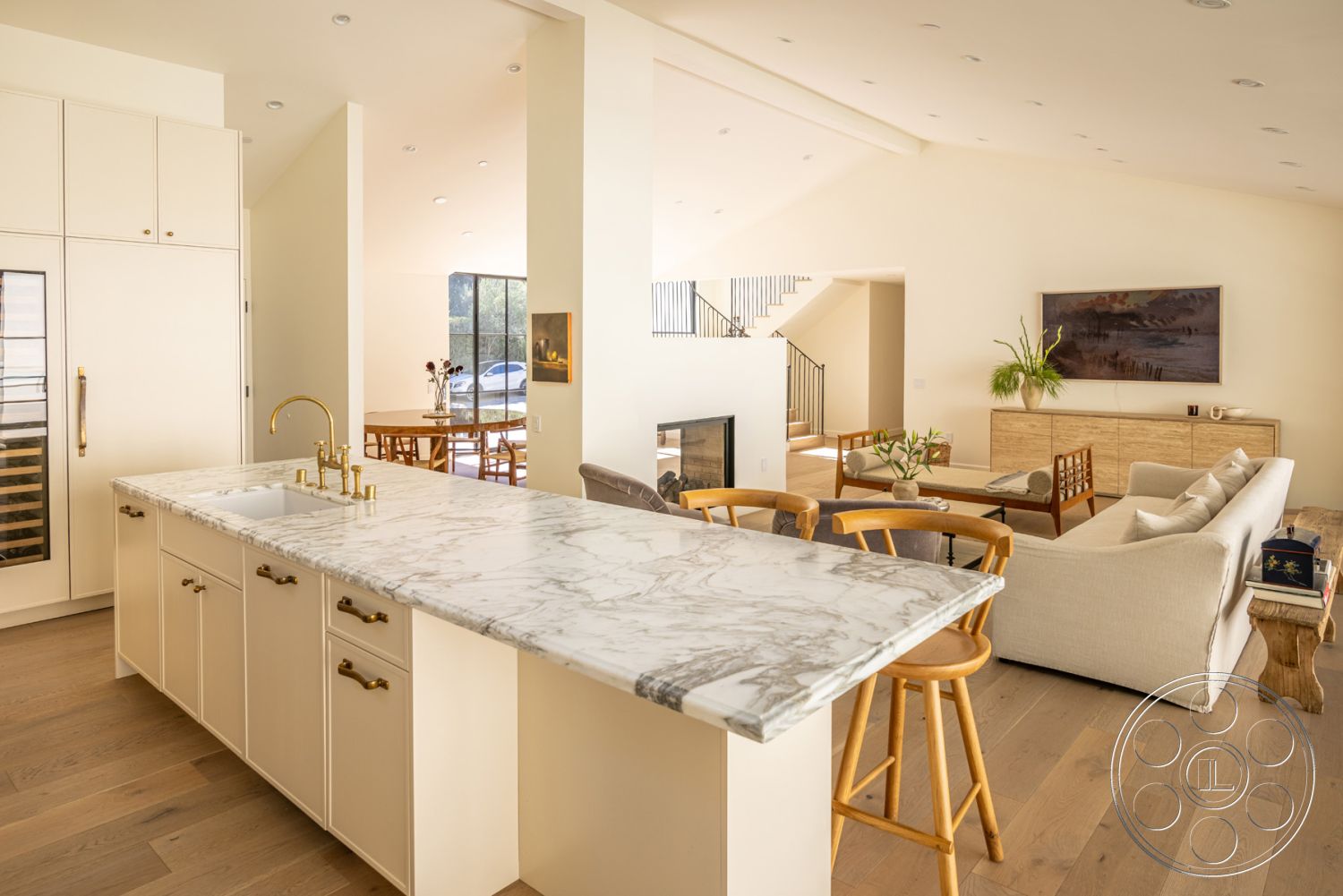 Modern Farmhouse 19 - neutral color palette, cozy seating arrangement, minimalist design elements, seamless indoor-outdoor flow, textured wall treatments, interior kitchen with marble countertop, natural light-filled environment, simple decorative accents, modern staircase with steel railings, white cabinetry with brass hardware, open-concept living space with hardwood floors, high-vaulted ceiling with recessed lighting, contemporary fireplace feature wall, airy living room with large floor-to-ceiling windows, dining area with wooden table and chairs, spacious chef's kitchen, elegant yet functional layout