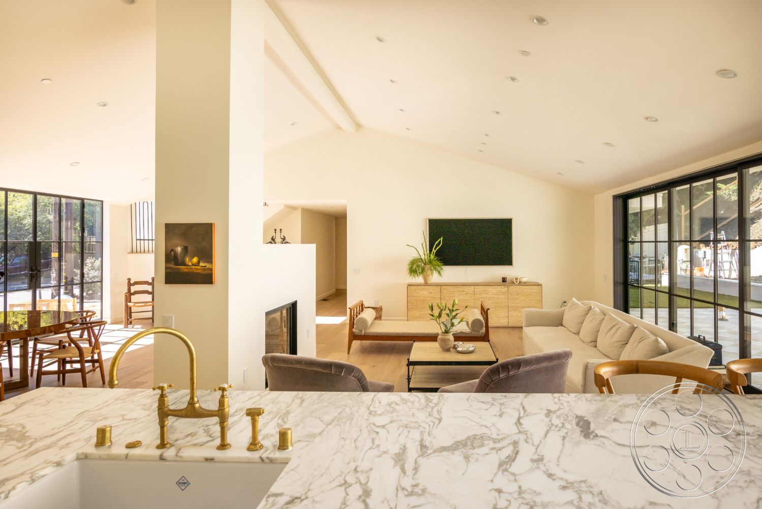 Modern Farmhouse 19 - minimalist decor, neutral color palette, textured wall art, indoor-outdoor flow, wood dining table, floor-to-ceiling windows, spacious living area, vaulted ceiling, rectangle coffee table, large sliding glass doors, urban garden view, gold faucet fixtures, sunny interior, hardwood living room floors, marble kitchen countertops, contemporary furniture design, white painted walls, modern lounge seating, open concept interior, exposed fireplace