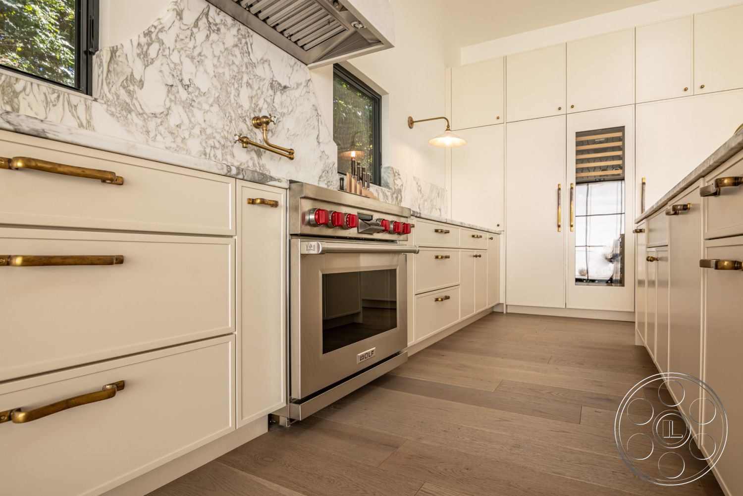 Modern Farmhouse 19 - contemporary kitchen design, modern kitchen cabinetry, stainless steel gas range, hardwood kitchen flooring, marble kitchen backsplash, high-end kitchen appliances, minimalist kitchen layout, interior kitchen with white painted walls, brass cabinet hardware, large kitchen windows for natural light
