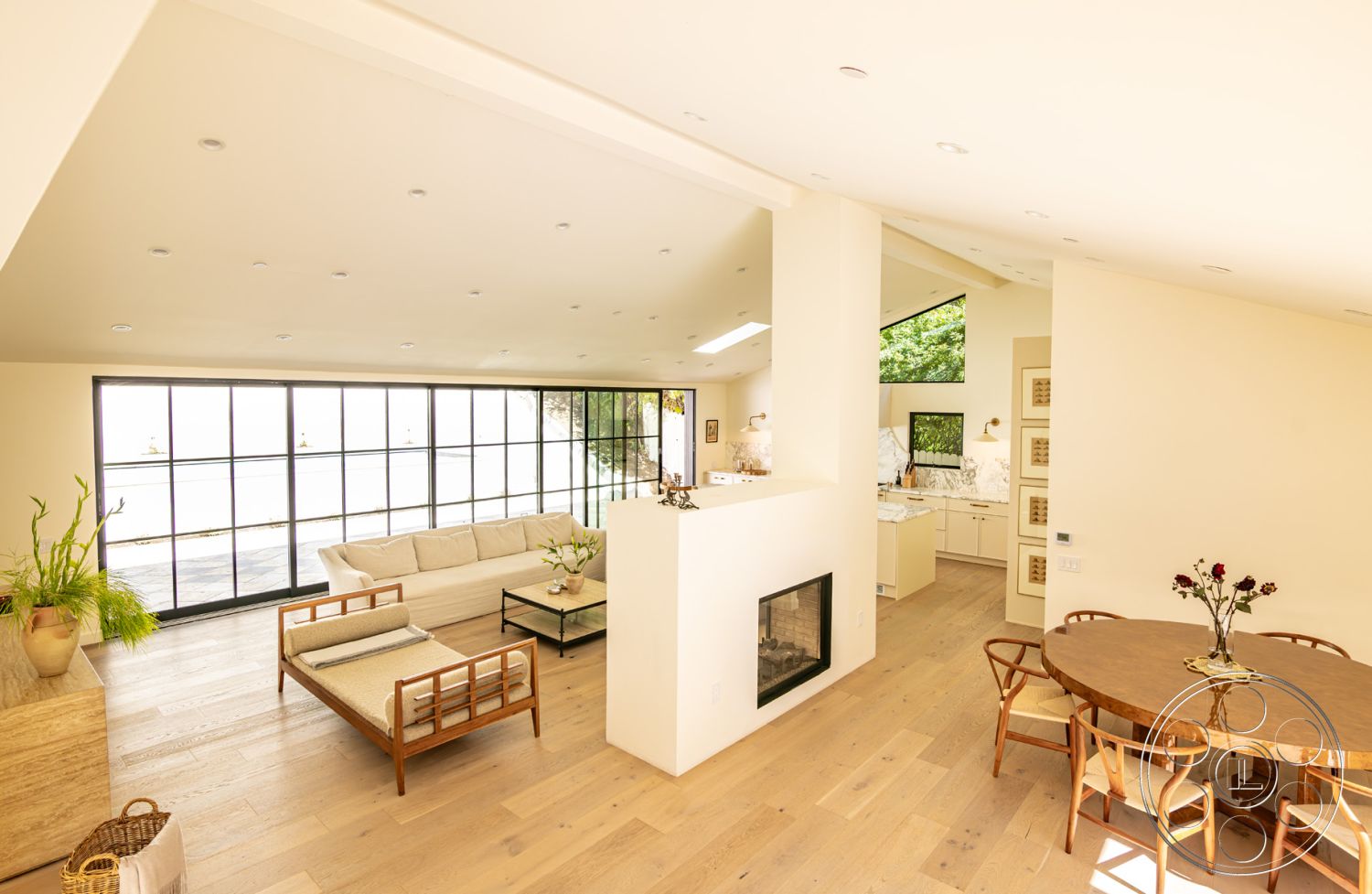 Modern Farmhouse 19 - floor-to-ceiling windows, open-concept living space, contemporary coffee table, contemporary architectural style, exposed wood ceiling beams, hardwood living room floors, interior seating area, built-in kitchen cabinets, white painted walls, suburban home setting, natural light-filled interior, rectangular living room layout, modern kitchen with marble countertops, modern dining room table, minimalistic fireplace surround, greenery accent with potted plants