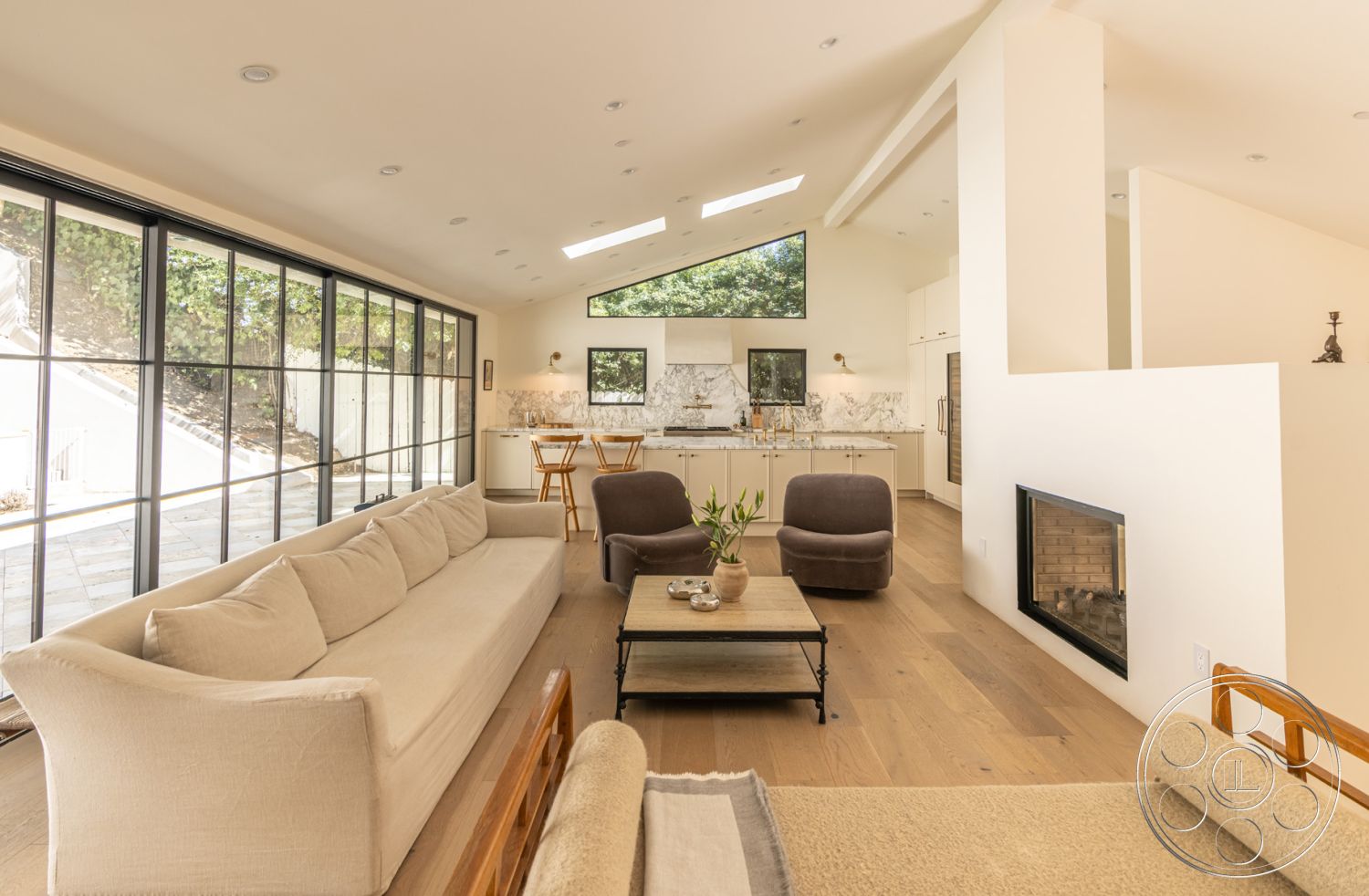 Modern Farmhouse 19 - interior open-concept layout, interior minimalist decor, interior hardwood living room floors, interior exposed wood ceiling beams, interior marble kitchen backsplash, interior modern design elements, interior floor-to-ceiling windows, interior white painted walls, interior cozy seating area, interior contemporary furniture, interior indoor plants, interior stone fireplace wall, interior vaulted living room ceiling, interior glass shower partition, interior natural light emphasis, interior decorative accents, interior designer coffee table, interior two-tone cabinetry in kitchen, interior black window frames, interior soft neutral palette