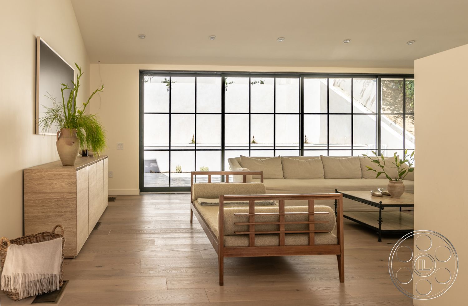 Modern Farmhouse 19 - interior neutral color palette, interior hardwood living room floors, interior large floor-to-ceiling windows, interior white painted walls, interior open layout, interior spacious living area, interior natural light filled space, interior contemporary architectural details, interior decorative potted plants, interior minimalist design furniture, interior textured coffee table, interior sleek modern sofa, interior modern wood cabinet, interior soft fabric cushions, interior minimalistic decor accents