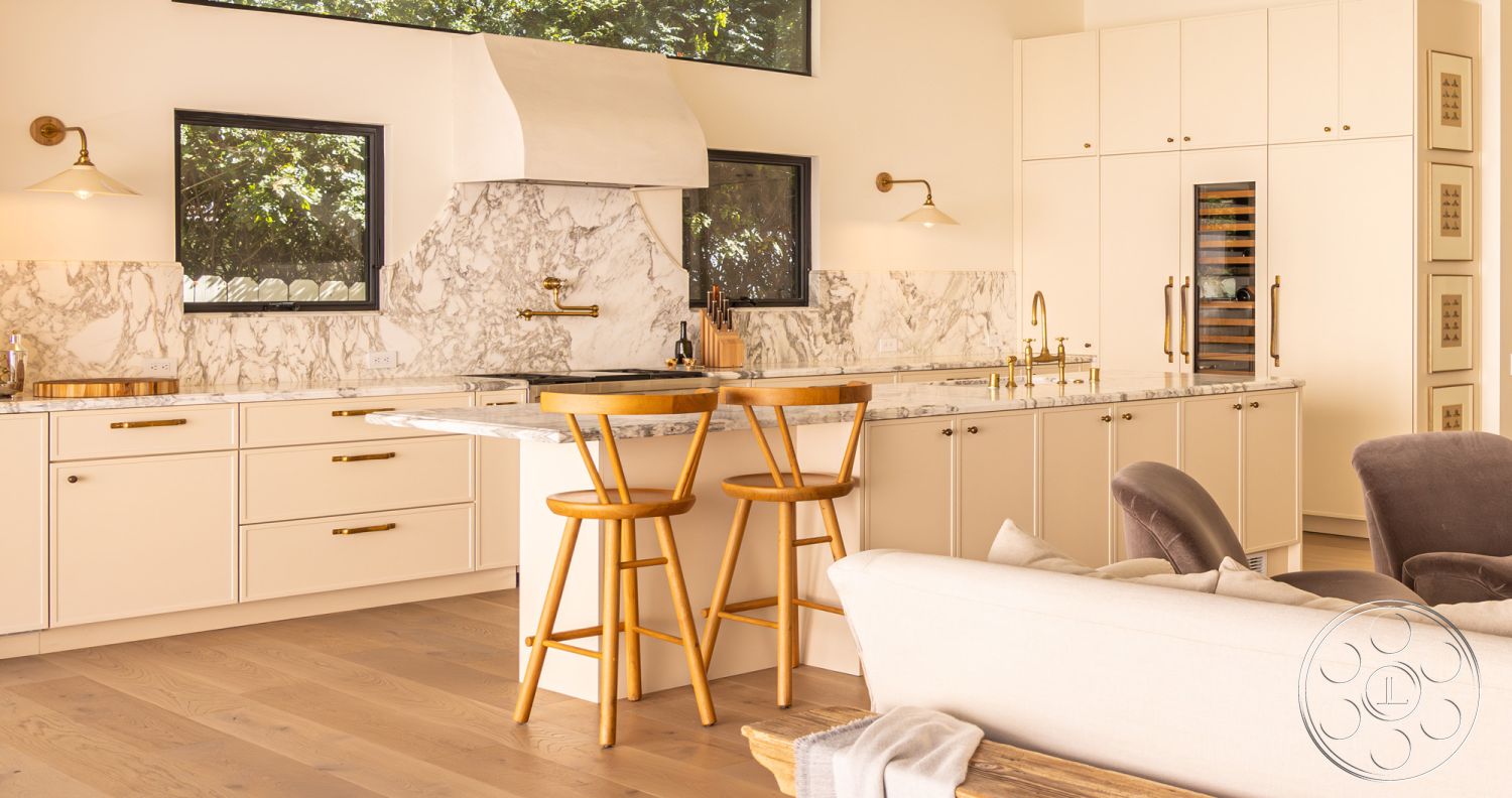 Modern Farmhouse 19 - neutral color palette, natural light, light hardwood flooring, stainless steel appliances, modern pendant lighting, floor-to-ceiling windows, textured wall treatment, open-concept layout, interior kitchen design, modern minimalist style, functional kitchen workspace, marble kitchen backsplash, marble countertop island, cozy living area, white shaker kitchen cabinets, gold finish cabinet hardware, pantry with built-in wine cooler, accent dining area, bar seating with wooden stools, elegant faucet fixtures