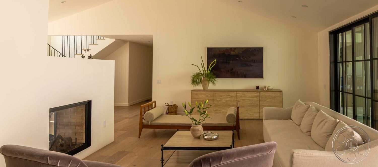 Modern Farmhouse 19 - minimalist decor, neutral color palette, open floor plan, floor-to-ceiling windows, textured plaster walls, soft lighting fixtures, contemporary aesthetic, suburban environment, built-in cabinetry, exposed wood ceiling beams, interior living space, vaulted living room ceiling, modern furniture design, concrete fireplace surround, plank hardwood living room floors, artwork wall design