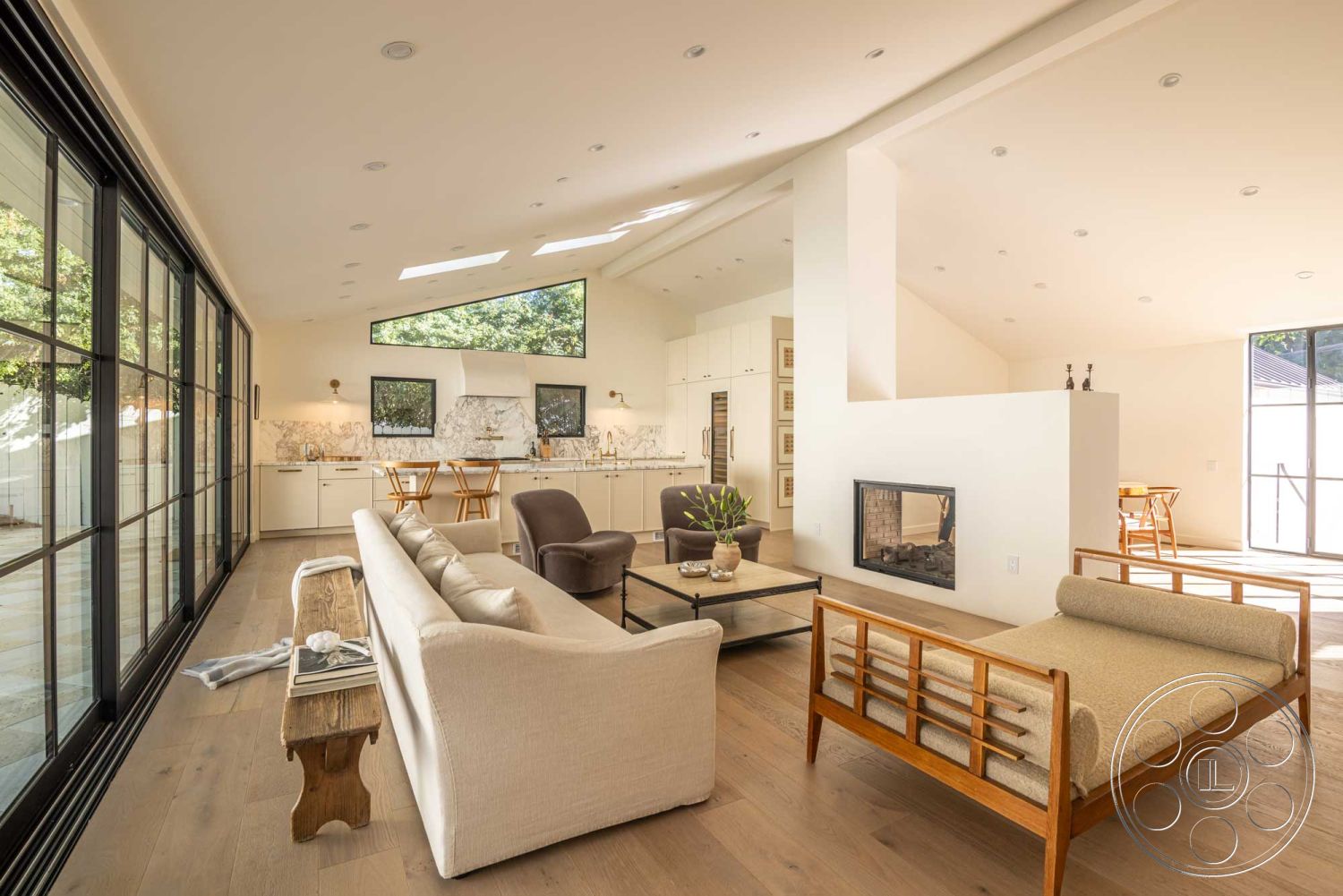 Modern Farmhouse 19 - open concept layout, interior hardwood living room floors, interior exposed wood ceiling beams, interior marble kitchen backsplash, interior floor-to-ceiling windows, interior open concept living area, interior white painted walls, suburban backyard view, interior recessed lighting fixtures, interior natural light ambiance, interior glass sliding doors, interior coffered ceiling, interior stone fireplace wall, interior sleek cabinetry, interior minimalist kitchen design, interior modern furniture decor, interior comfortable seating area, interior contemporary art accents, kitchen dining area, living room seating arrangement, large glass windows view