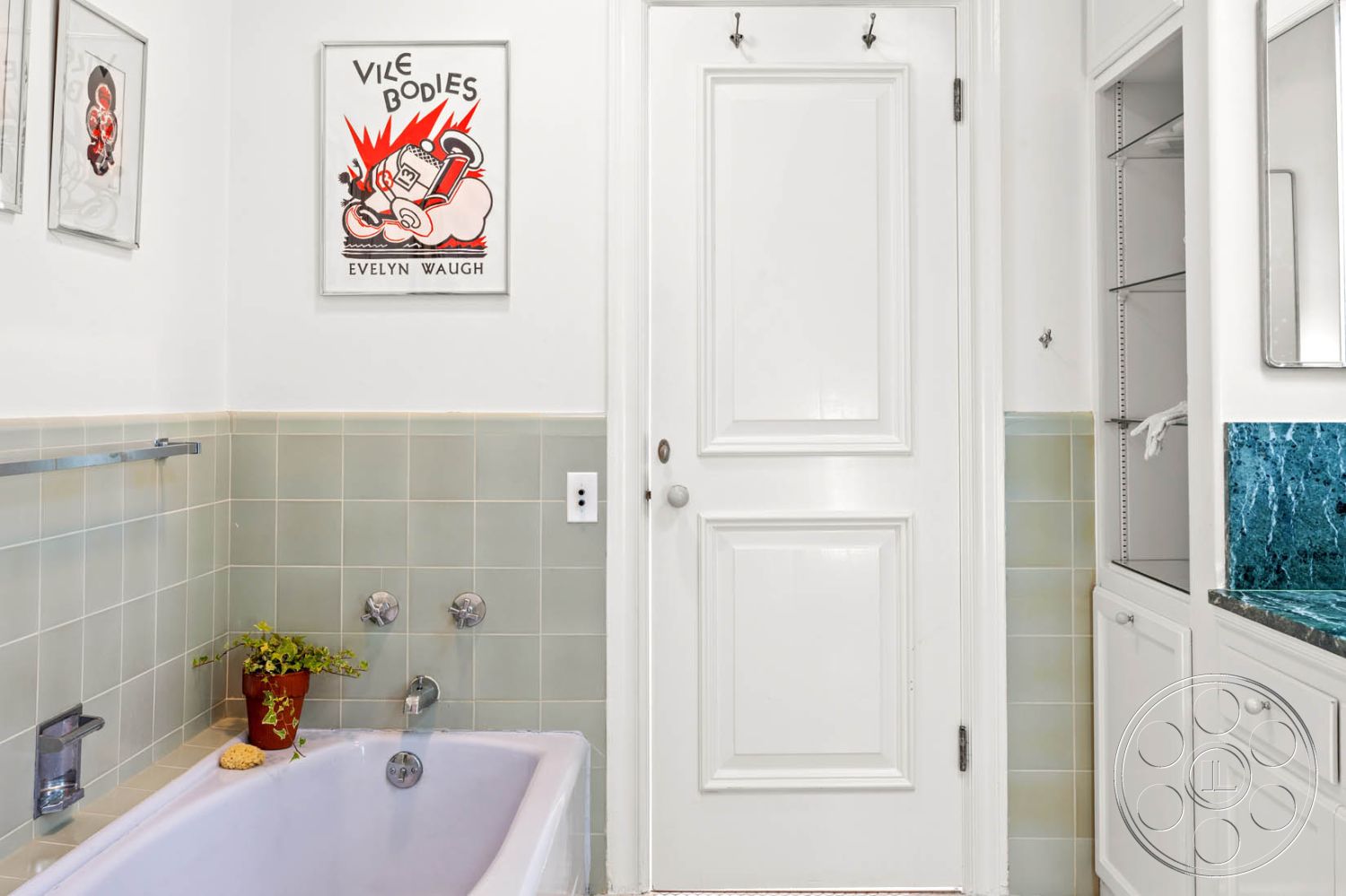 English 60 - plant decor, green glazed tile bathroom walls, interior bathroom, white painted walls, textured wall details, glass shower partition, marble bathroom countertop, white trim details, brushed nickel faucet fixtures, pink freestanding bathtub, built-in bathroom cabinets, vintage art deco wall art, white panel door