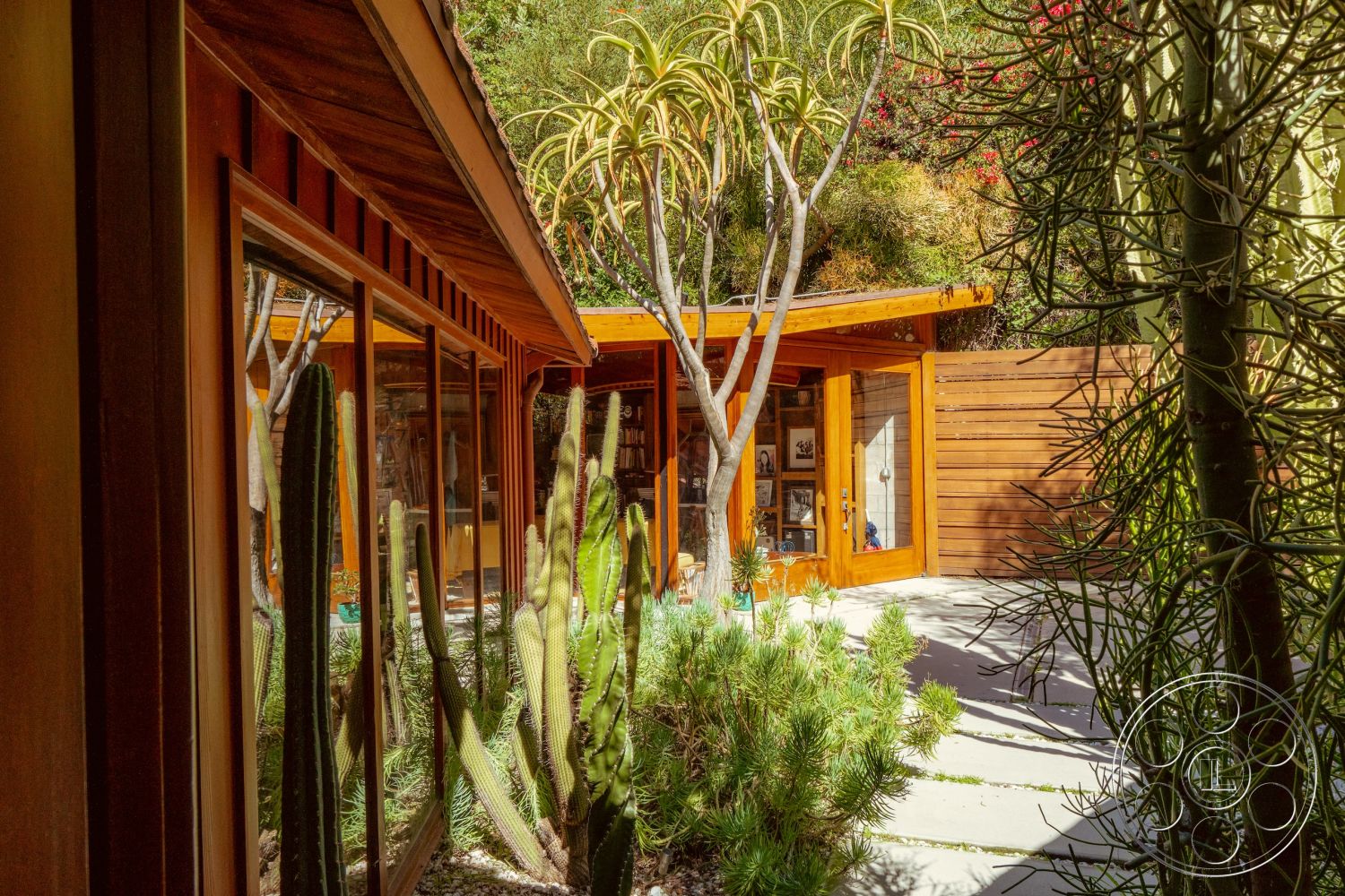 Pad 90210 - interior natural light, exterior landscaped garden, exterior recessed lighting, exterior wood paneling, interior open living space, exterior concrete patio flooring, interior modern decor, exterior natural wood trim, interior warm wood tones, exterior minimalist design, exterior desert landscape, interior glass windows, exterior desert cactus plants, interior vaulted wooden ceiling, interior framed glass door