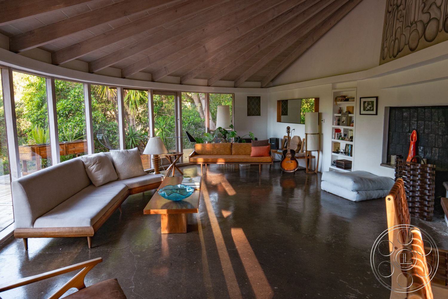 Pad 90210 - exterior, minimalist design, textured wall art, polished concrete flooring, built-in bookshelf, open living space, mid-century modern style, exposed wood ceiling beams, indoor plant accents, cozy living area, decorative ceramic bowl, wooden lounge seating, curved glass walls, natural light enrichment, secluded garden view, artistic sculpture decor