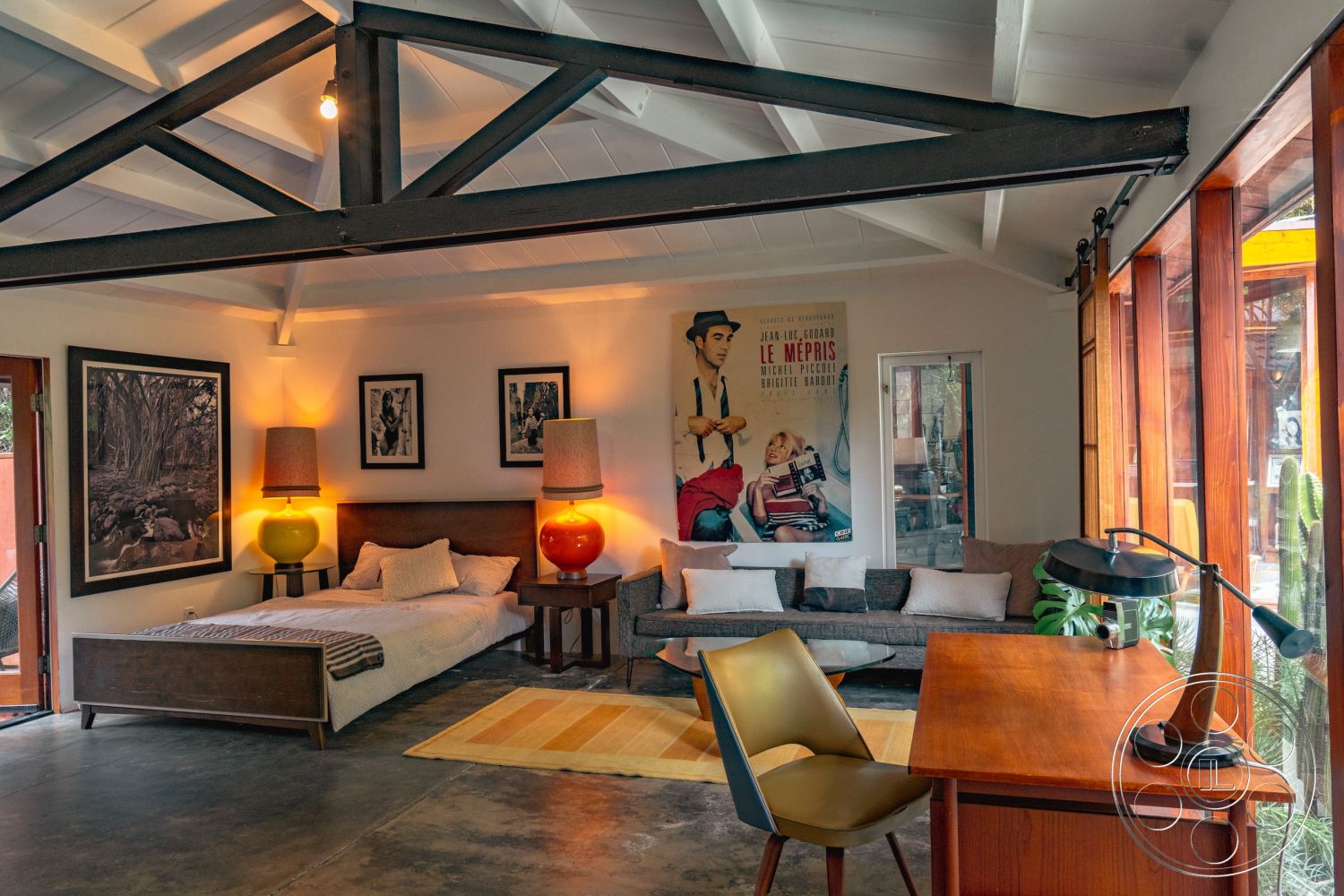 Pad 90210 - minimalist furniture arrangement interior, glass sliding doors interior, neutral color palette interior, exposed wood ceiling beams interior, open floor plan interior, stone accent wall interior, concrete floor interior, decorative throw pillows interior, cozy reading nook interior, textured area rug interior, artistic wall decor interior, mid-century modern design style interior, modern wooden bed frame interior, large bay windows interior, vintage film posters wall treatment interior, contemporary armchair interior, functional workspace desk interior, colorful table lamps interior, warm lighting fixtures interior