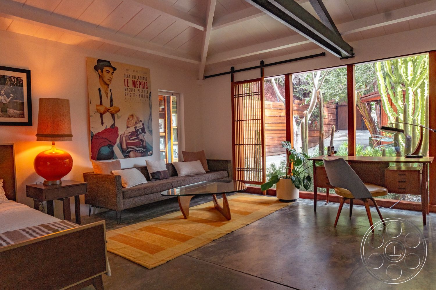 Pad 90210 - minimalist decor, textured wall art, concrete flooring, green plant accents, sliding glass doors, floor-to-ceiling windows, soft area rug, stylish coffee table, bright color accents, urban garden view, wooden accent wall, mid-century modern design, exposed wood ceiling beams, natural light interior, open living area, designer table lamp, modern upholstered sofa, wooden desk with chair, modern art prints