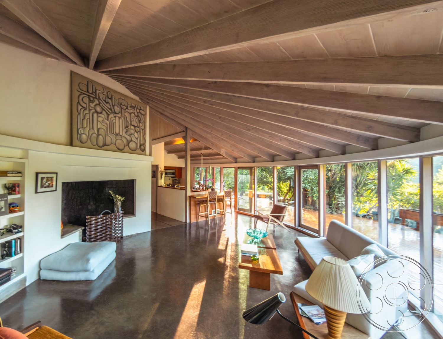 Pad 90210 - exposed wood ceiling beams interior, slate floor dining room interior, built-in bookshelves living room interior, large glass windows living room interior, modern minimalist fireplace interior, open-concept kitchen living area interior, geometric art wall feature interior, wooden dining table kitchen interior, transparent glass door interior, rounded sofa living room interior, natural light-filled spaces interior, contemporary coffee table living room interior