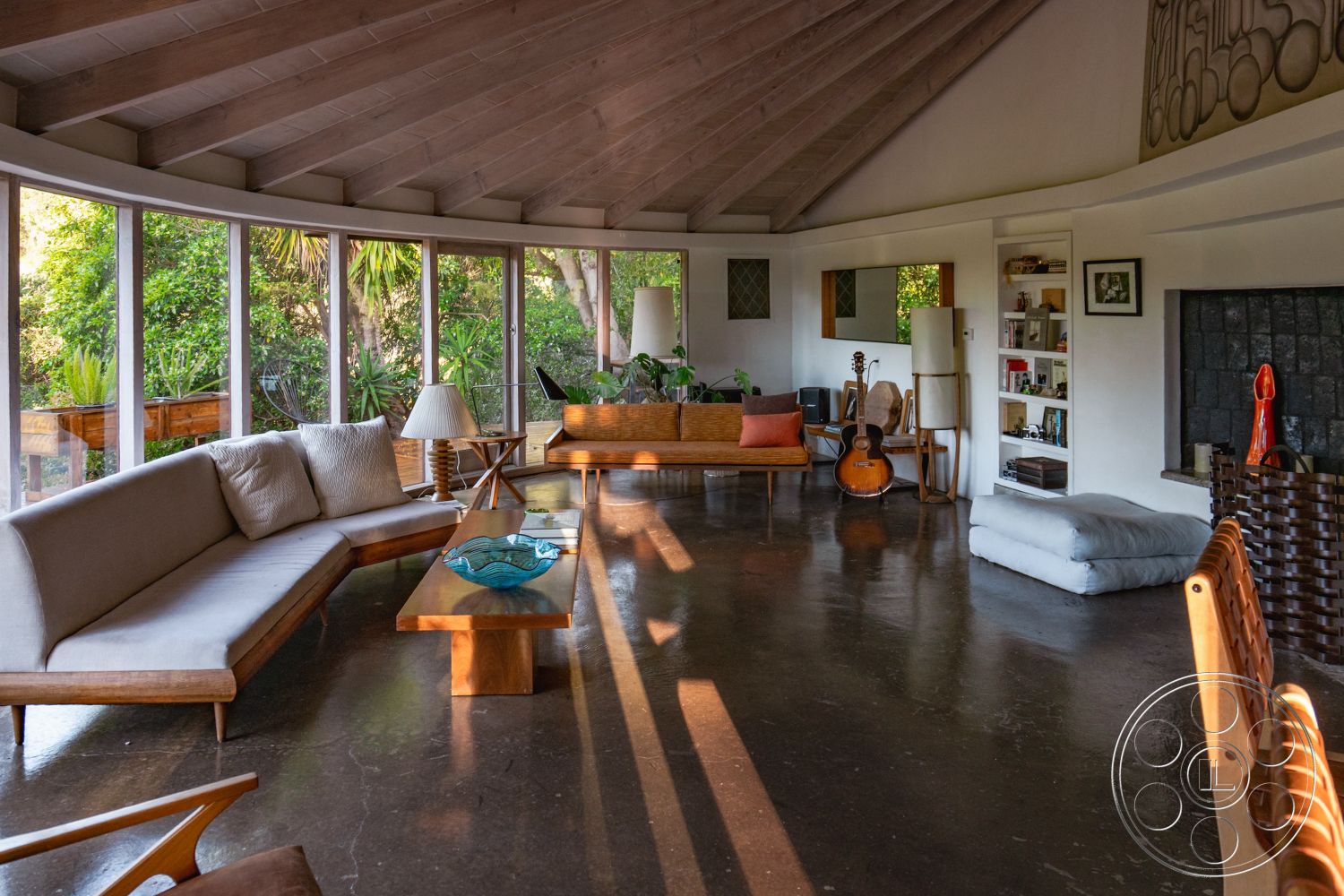 Pad 90210 - plant decor, open floor plan, concrete flooring, minimalist design elements, built-in shelves, rustic light fixtures, curved wall design, textured wall treatments, cozy reading nook, modern lounge area, mid-century modern architecture, exposed wood ceiling beams, large windows with garden view, wooden furniture accents, natural light emphasis