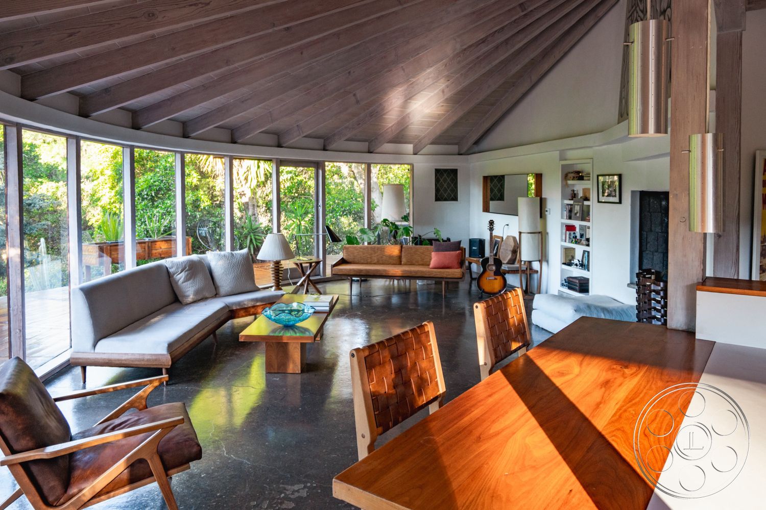 Pad 90210 - minimalist decor, natural lighting, indoor plants, polished concrete flooring, large glass windows, greenery view, natural wood dining table, open concept living space, textured wall finishes, seamless indoor-outdoor flow, mid-century modern furniture, contemporary lighting fixtures, exposed wood ceiling beams, curved interior walls, wooden sofa frames