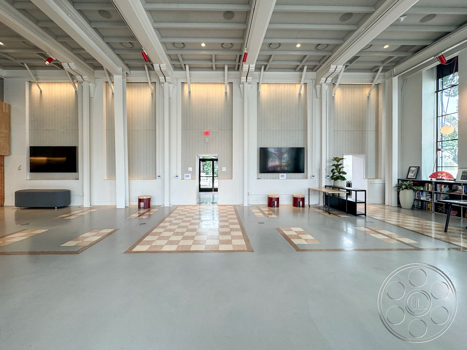 Studio 101 - minimalist decor, natural light, contemporary design, open layout, modern furniture, concrete flooring, interior space, urban setting, floor-to-ceiling windows, industrial lighting fixtures, light gray walls, neutral color scheme, exposed ceiling beams, potted indoor plants, wood paneling walls, functional work area, multifunctional room, checkerboard tile pattern, art gallery atmosphere, subtle texture in walls