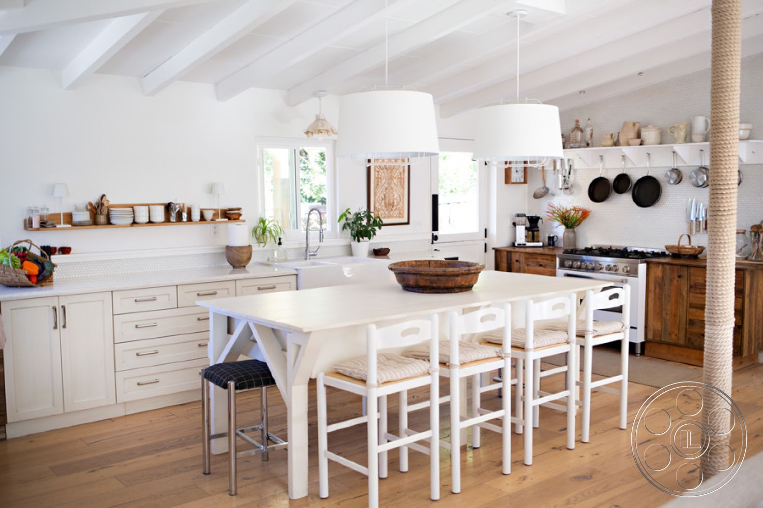 Ranch 33 - textured wall art, stainless steel kitchen appliances, natural light from large window, wooden kitchen cabinets, functional kitchen workspace, granite kitchen countertops, hardwood kitchen floors, white shiplap ceiling, interior kitchen with white painted walls, minimalist modern design, open concept chef's kitchen, double pendant light fixtures, large farmhouse dining table, woven seat bar stools, kitchen with breakfast bar, decorative kitchen shelf