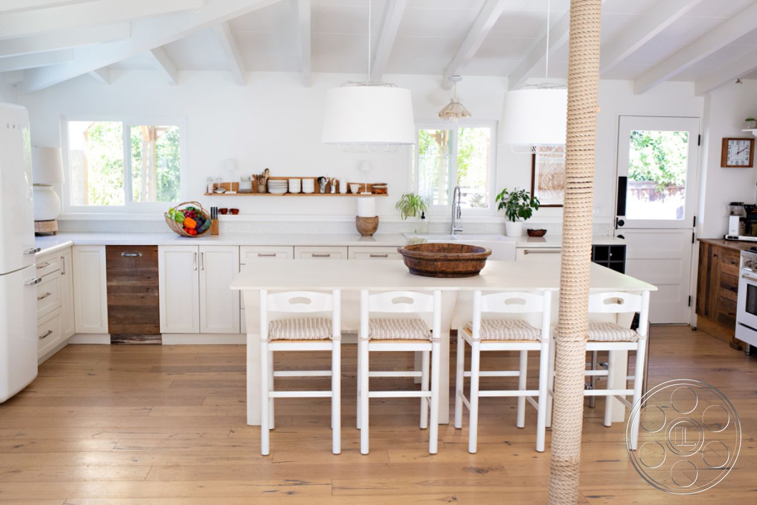 Ranch 33 - stainless steel appliances, light wood accents, modern farmhouse style, pendant lighting fixtures, textured tile backsplash, large kitchen island, exposed wood ceiling beams, interior kitchen, open-concept kitchen layout, hardwood kitchen floors, white painted walls, shaker-style kitchen cabinets, quartz kitchen countertops, natural light with large windows, woven barstool seating