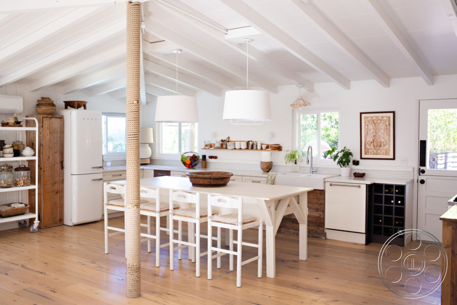 Ranch 33 - neutral color palette, stainless steel appliances, wooden dining table, natural light from large windows, natural wood shelving, exposed wood ceiling beams, interior kitchen space, minimalist kitchen design, hardwood kitchen flooring, white painted walls, open concept kitchen layout, shiplap wall treatment, modern pendant lights, kitchen island with built-in seating, glass tile backsplash, woven seat barstools, vintage refrigerator