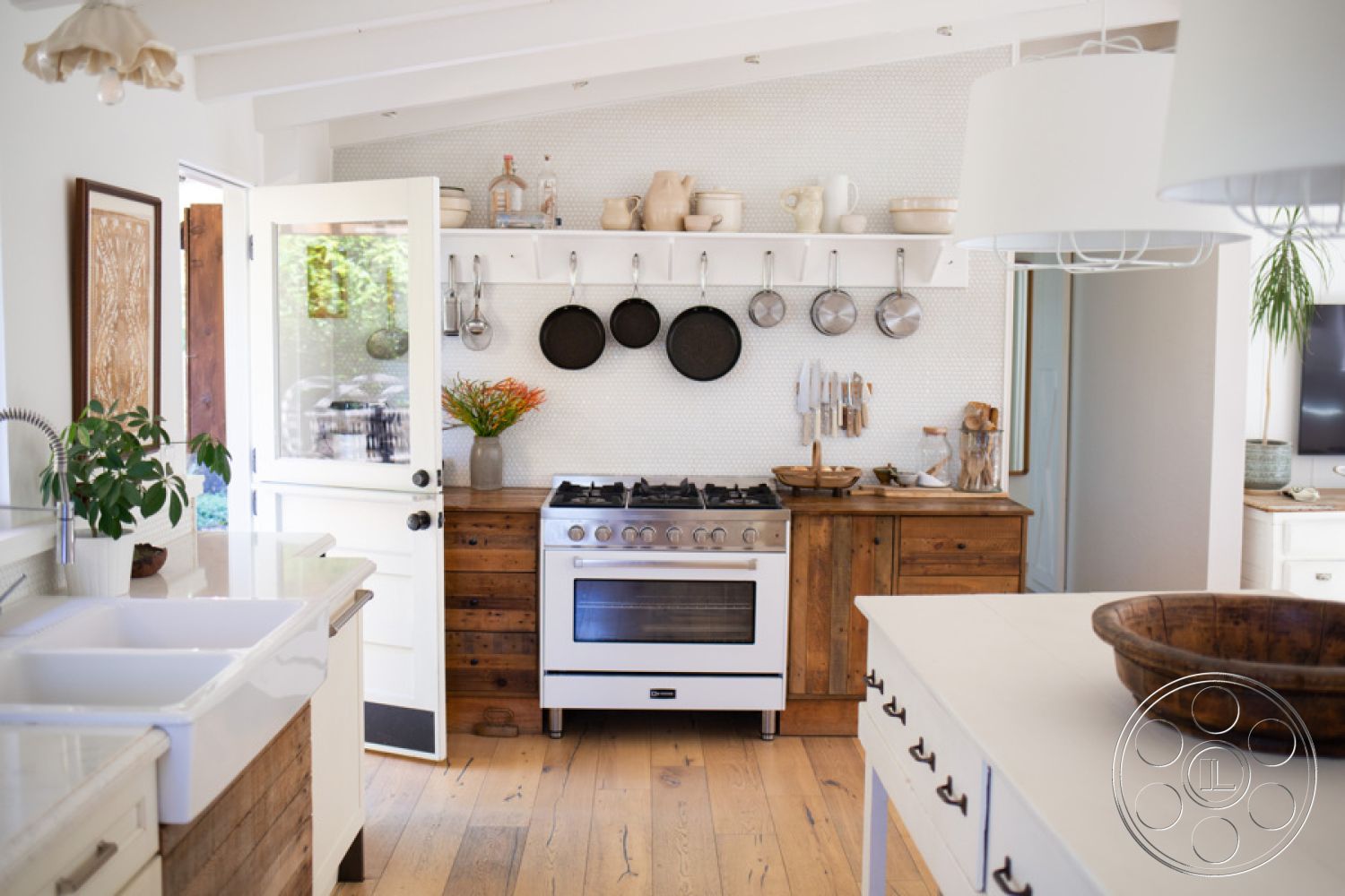 Ranch 33 - natural wood cabinetry, open concept layout, modern farmhouse style, functional kitchen design, exposed wood ceiling beams, stainless steel kitchen appliances, hardwood kitchen floors, farmhouse sink, cozy dining nook, shaker-style kitchen cabinets, natural light filled interior, large glass door entrance, white painted kitchen walls, decorative white backsplash, hanging cookware storage, wooden countertop accents, vintage kitchen decor, inviting kitchen atmosphere