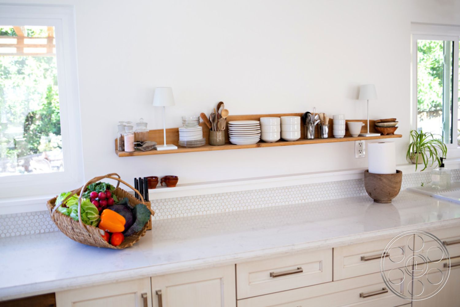 Ranch 33 - natural light, minimalist design, open shelving, wooden shelving, marble countertop, casual dining, hexagonal tile backsplash, functional kitchen layout, interior kitchen, white painted walls, modern interior lighting, stainless steel utensils, fruit basket décor