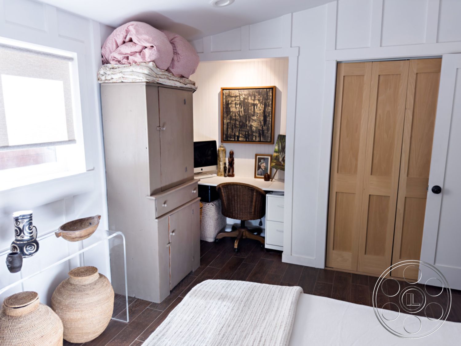 Ranch 33 - woven basket decor, framed wall art, textured throw blanket, home office area, natural light from window, hardwood bedroom floors, white painted walls, shiplap accent wall, barn door closet, glass decorative accents