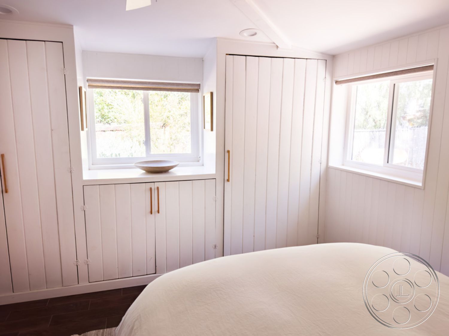 Ranch 33 - interior neutral color palette, interior recessed lighting, interior hardwood bedroom floors, interior spacious layout, interior minimalist cabinetry, interior brushed gold hardware, exterior white shiplap walls, interior large double-glazed windows, interior natural light fill, interior window seat with bowl