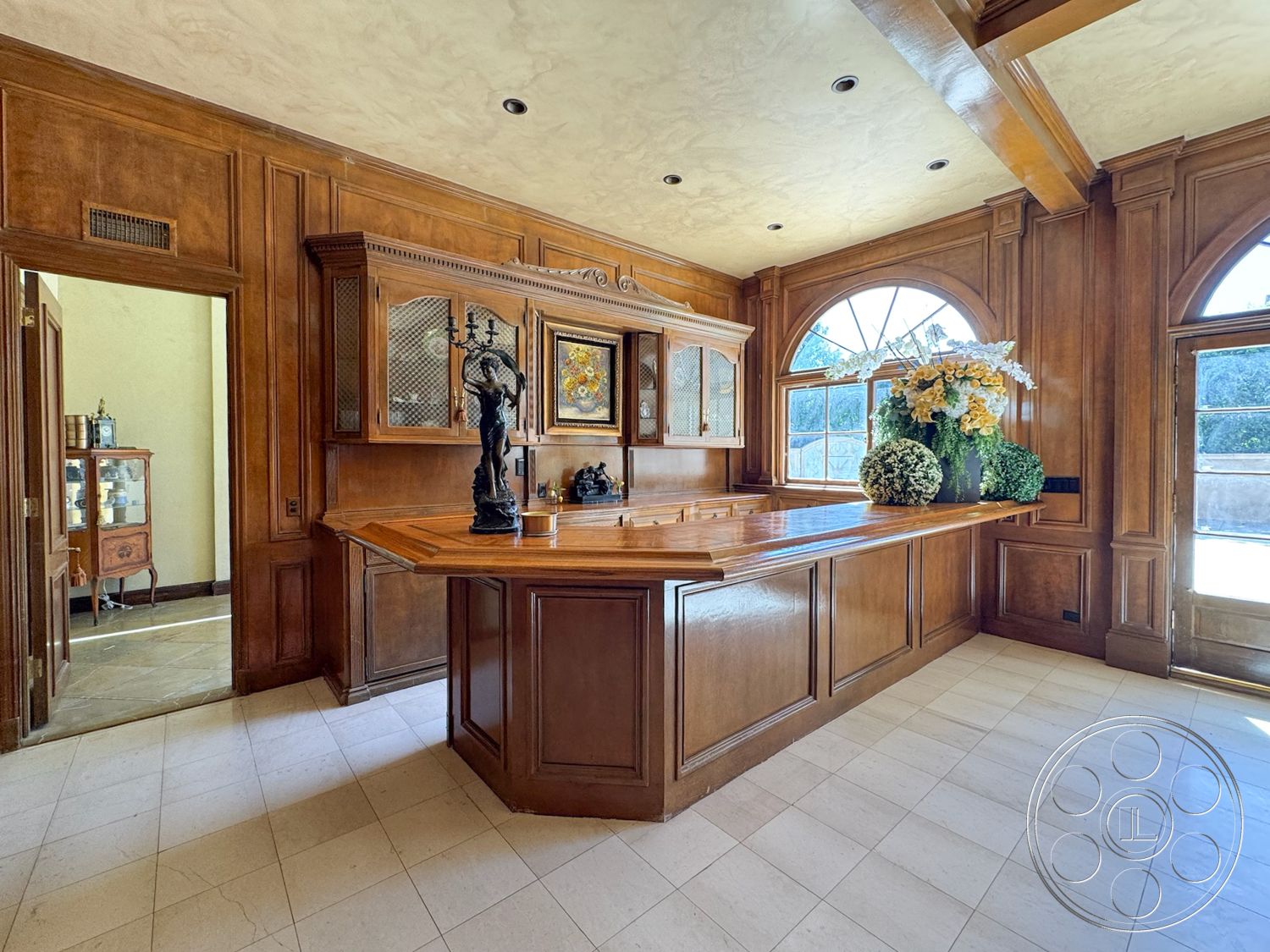 Mansion 146 - natural light, exterior, open floor plan, traditional architecture, polished marble flooring, luxurious ambiance, bar area, arched windows, ornate ceiling details, dining space, large indoor plants, wood beam ceiling, wood paneling walls, historic home interior, elegant interior design, stained wood bar countertop, glass decorative cabinet doors, vintage decorative statue, high-end craftsmanship