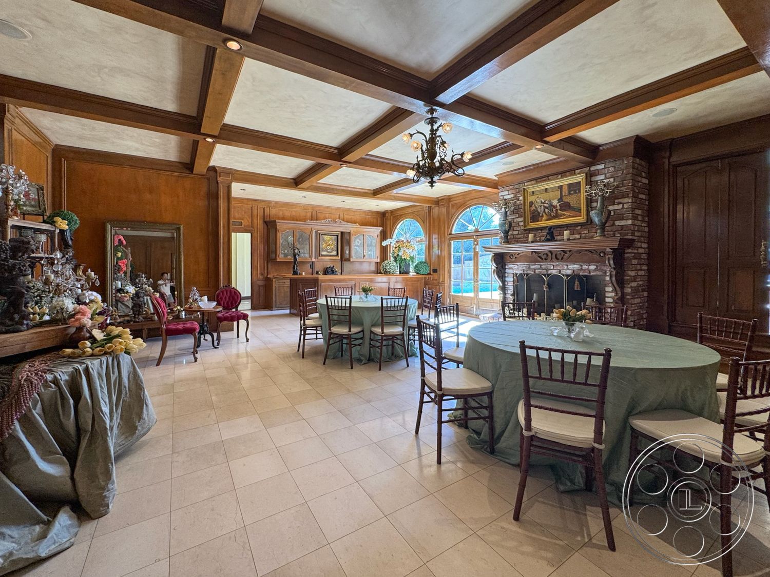 Mansion 146 - exposed wood ceiling beams interior, brick fireplace surround interior, textured plaster ceiling interior, tumbled marble flooring interior, wood paneling accent walls interior, custom built-in cabinets interior, oval dining tables interior, chandelier with multiple bulbs interior, arched windows with decorative trim interior, traditional dining area with vintage decor interior