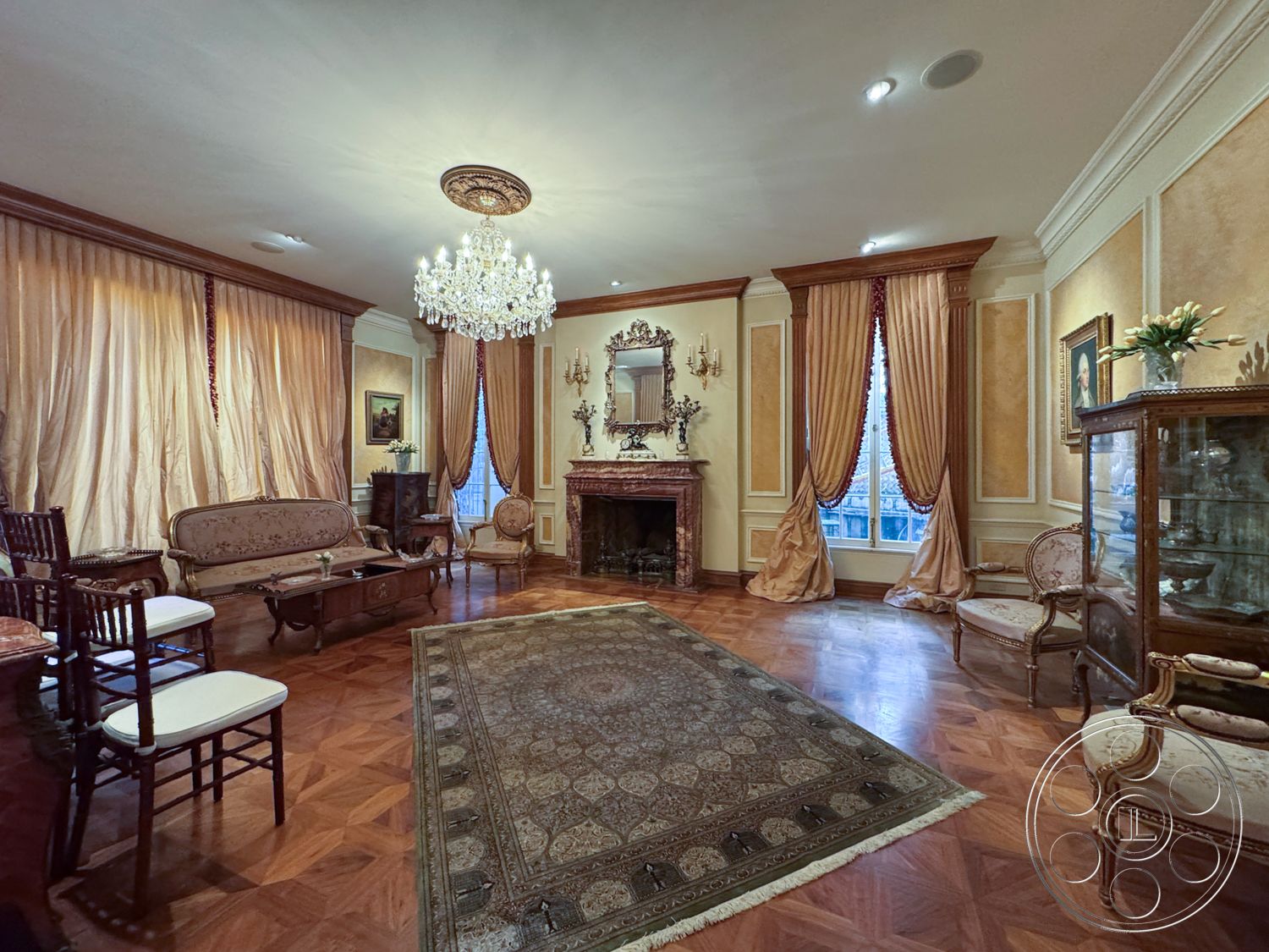 Mansion 146 - neutral color palette, crystal chandelier, vintage decor elements, plush area rug, brass wall sconces, gold-framed mirror, crown molding details, hardwood parquet flooring, elegant sitting area, exposed chandelier lighting, ornate marble fireplace, silk drapery curtains, antique wooden armchairs, traditional wall paneling, classic oil paintings, decorative glass display cabinet, intricate ceiling medallion, vintage style furnishings, refined architectural details