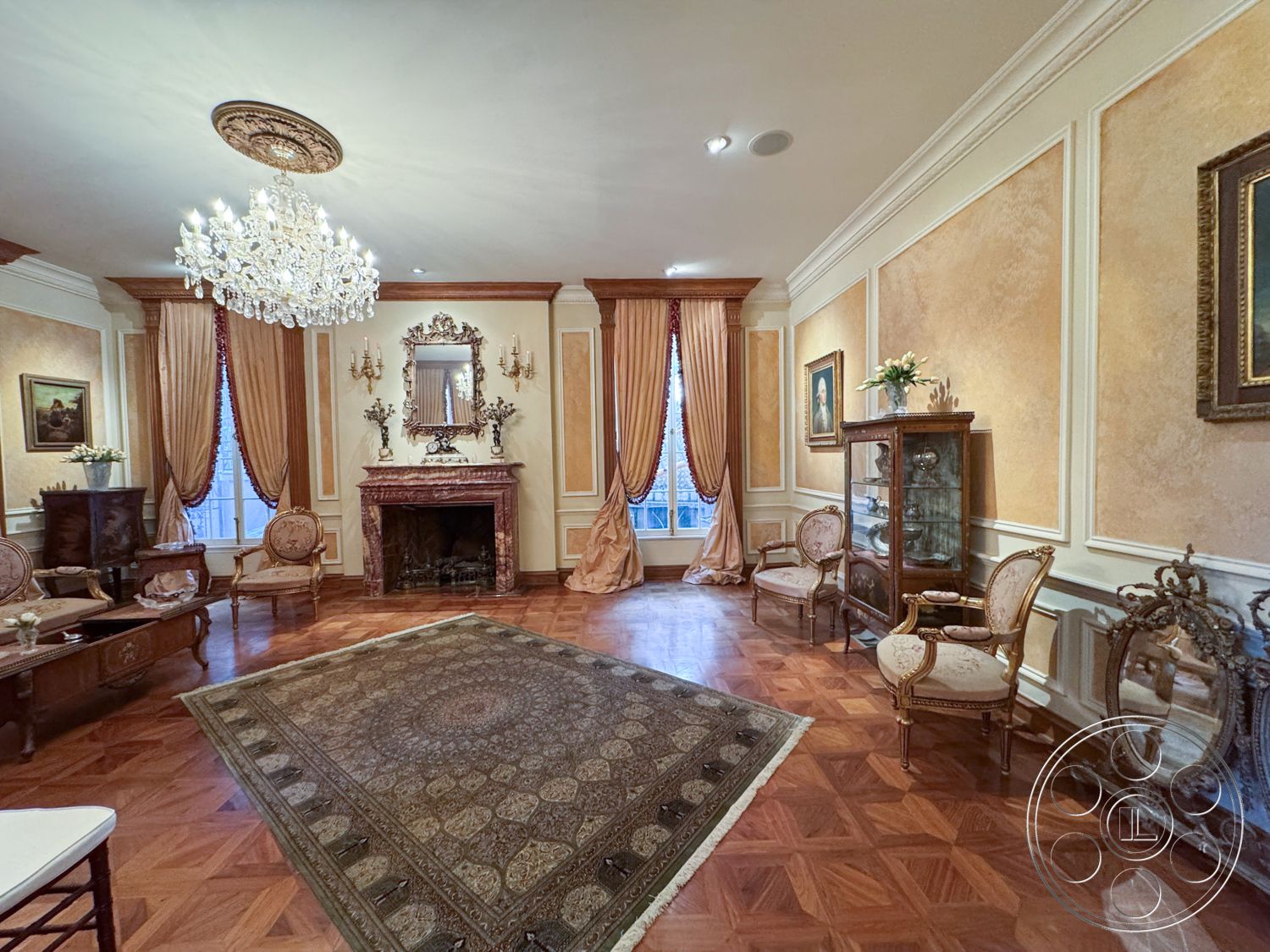 Mansion 146 - soft ambient lighting, textured plaster walls, decorative sconces, dark wood paneling, marble fireplace surround, parquet hardwood flooring, crown molding details, gold chandelier lighting, ornate mirror above fireplace, intricate area rug, heavy silk drapes, classic armchairs with upholstery, antique wooden cabinet, traditional artwork, luxurious seating area, elegant room layout, symmetrical window arrangement