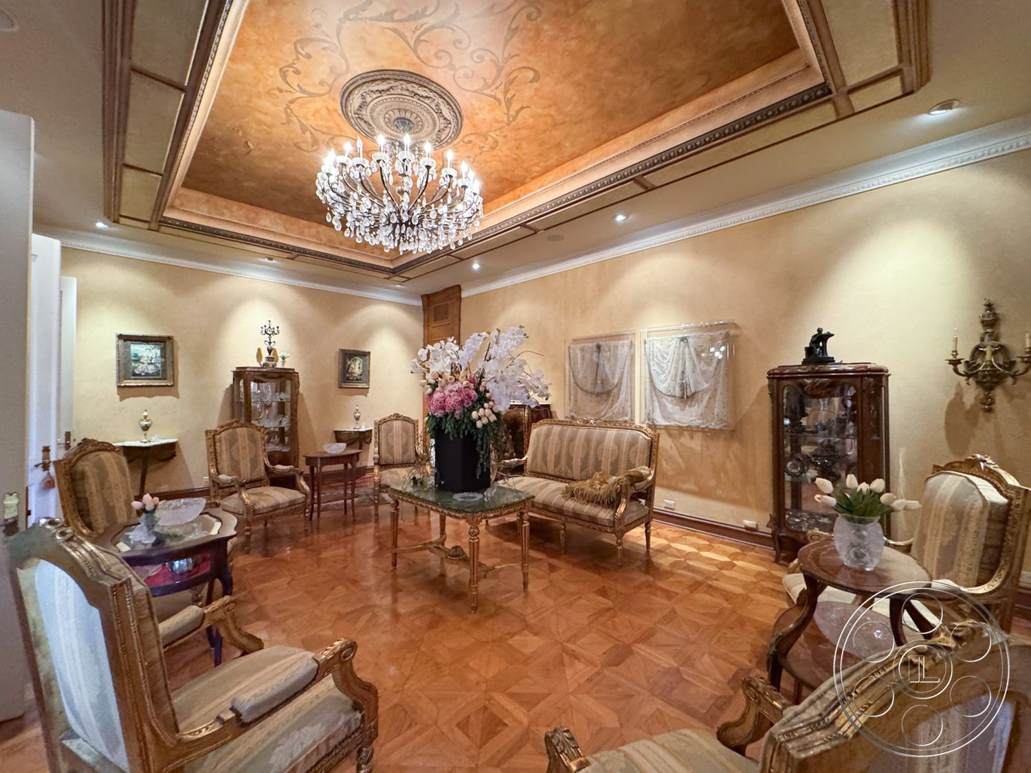 Mansion 146 - chandelier lighting, wall sconces, classic design elements, soft ambient lighting, vintage decor, textured plaster walls, luxurious atmosphere, elegant side tables, parquet hardwood flooring, decorative ceiling medallion, exquisite wall art, floral centerpiece arrangement, traditional armchairs, gold leaf ceiling detail, ornate wall molding, glass-topped coffee table, antique display cabinet, richly decorated room, symmetrical furniture layout
